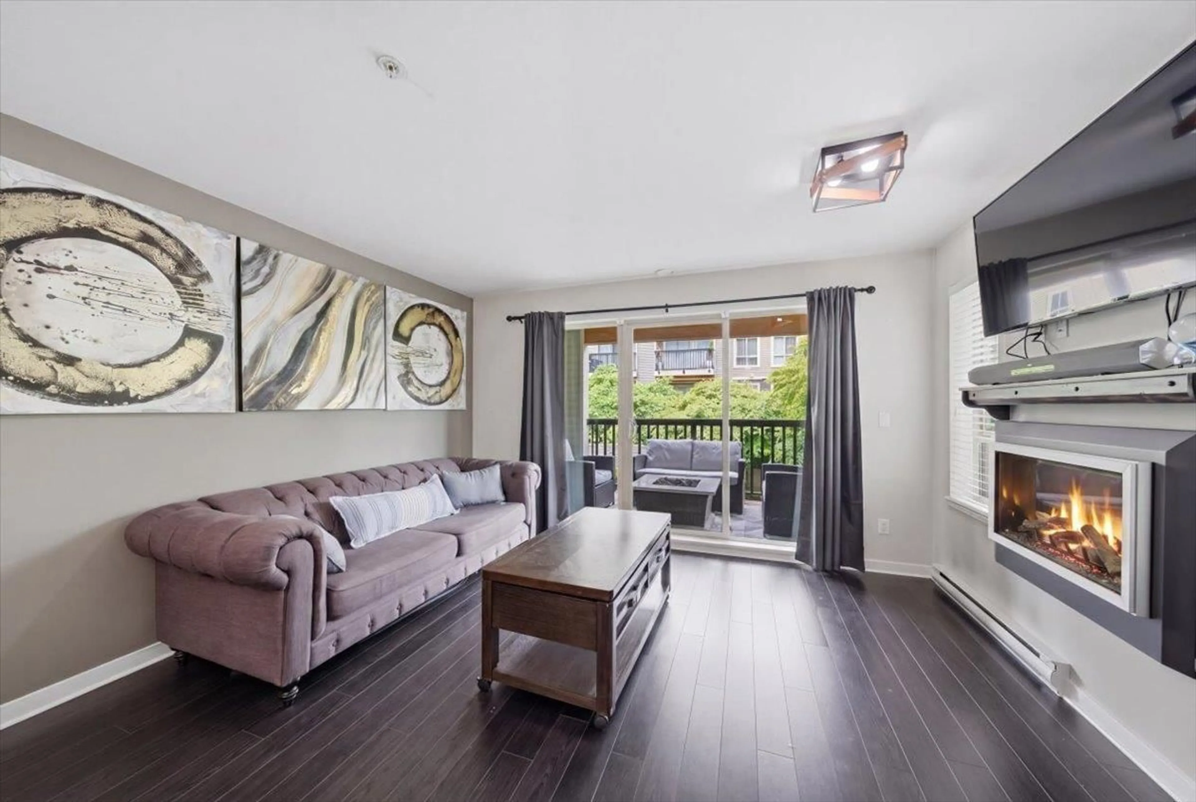 Living room with furniture, wood/laminate floor for 215 - 21009 56 AVENUE, Langley British Columbia V3A0C9