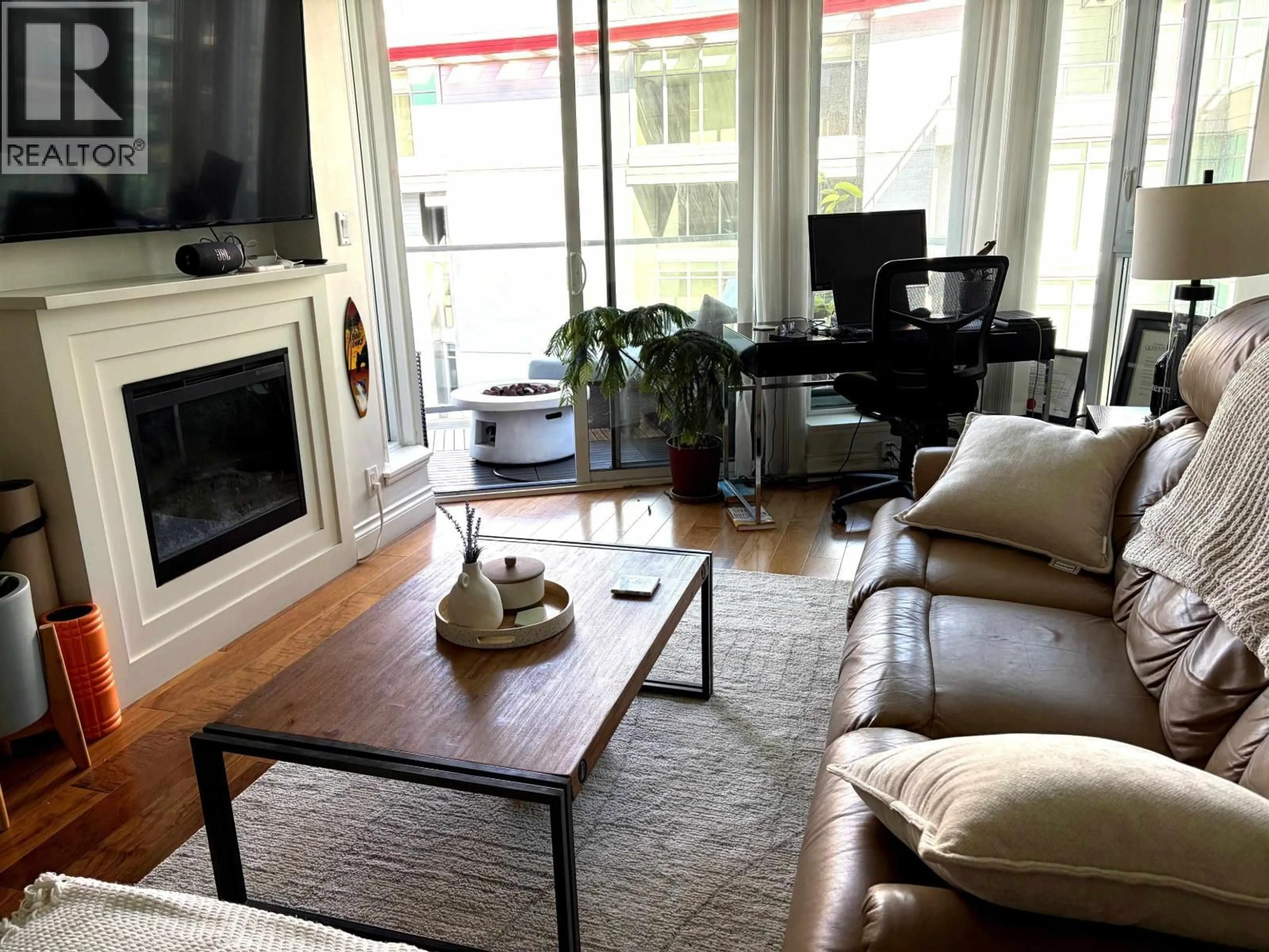 Living room with furniture, wood/laminate floor for 808 - 199 VICTORY SHIP WAY, North Vancouver British Columbia V7L0B2