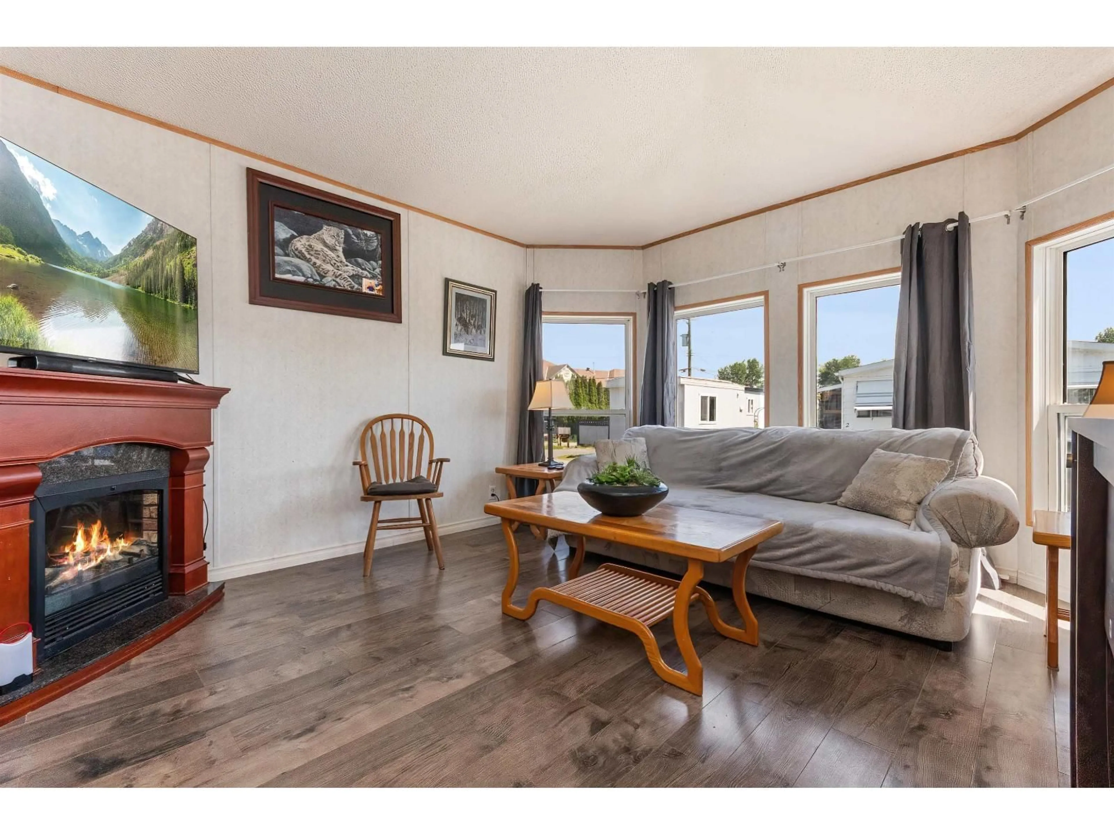 Living room with furniture, wood/laminate floor for 22 - 26892 FRASER HIGHWAY, Langley British Columbia V4W3T5