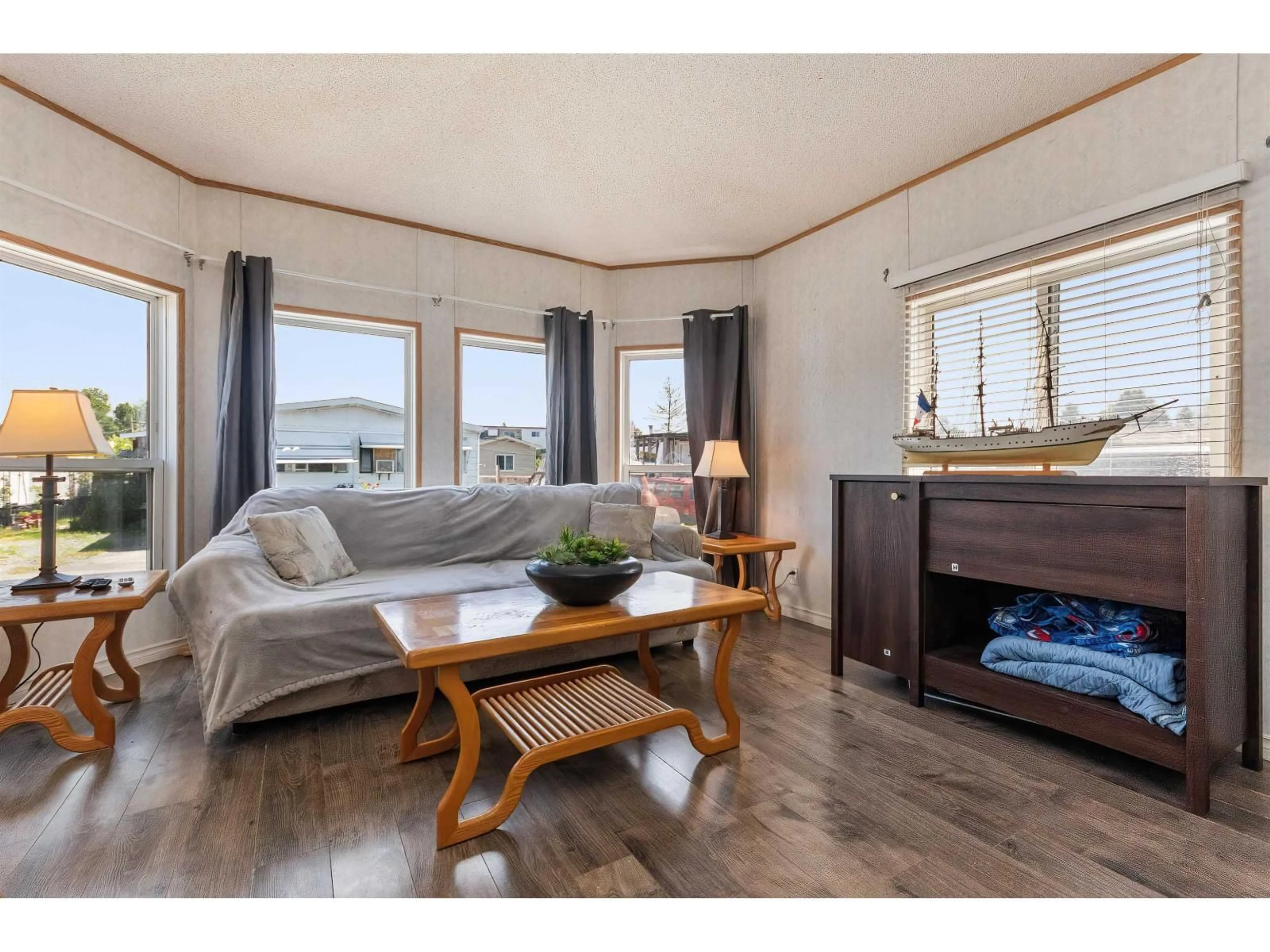 Living room with furniture, wood/laminate floor for 22 - 26892 FRASER HIGHWAY, Langley British Columbia V4W3T5