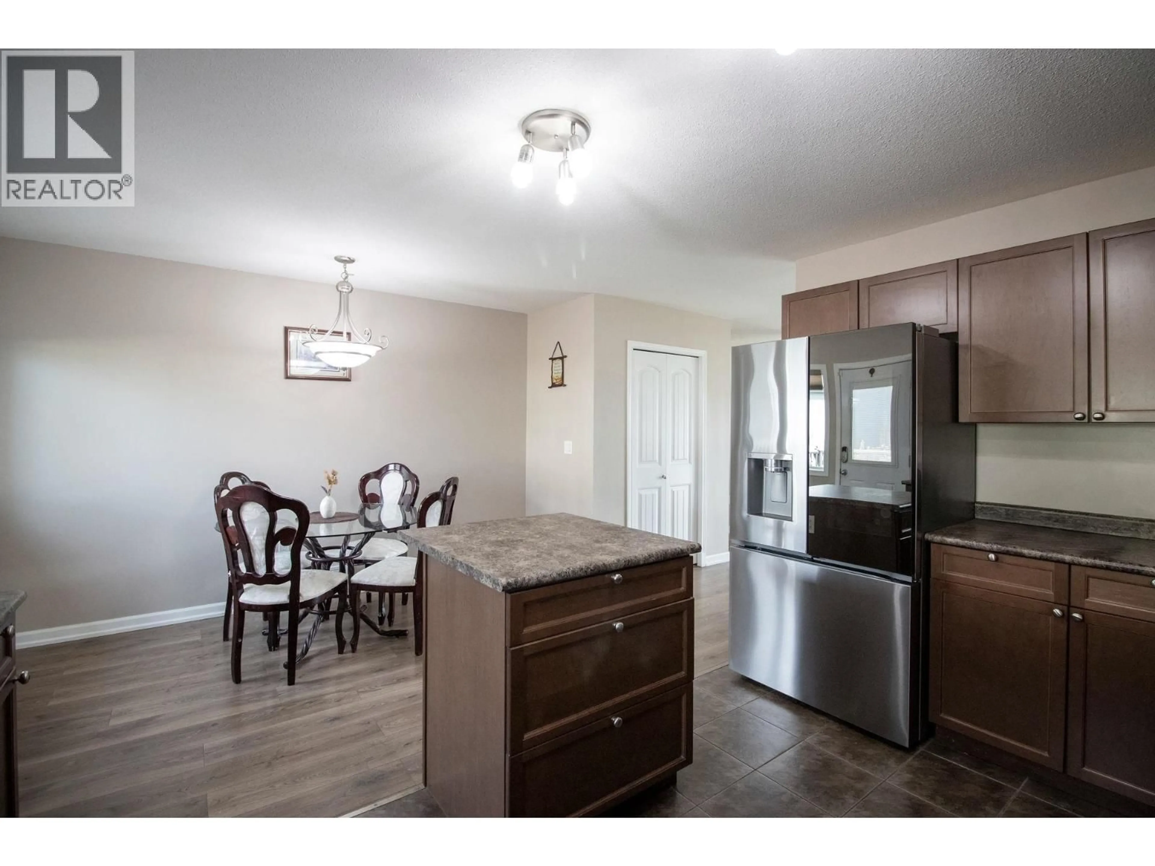 Open concept kitchen, wood/laminate floor for 10711 109A STREET, Fort St. John British Columbia V1J0L2