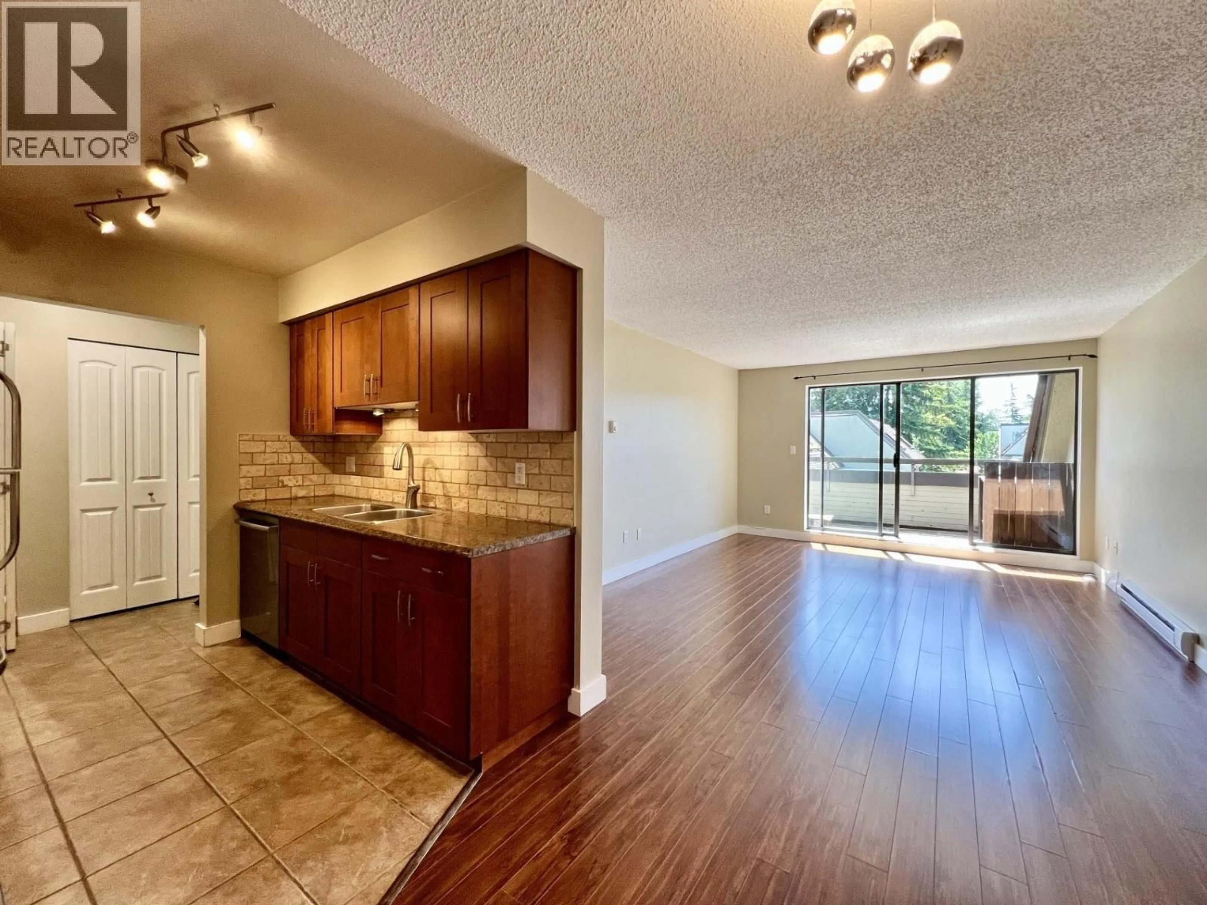 Open concept kitchen, wood/laminate floor for 401 - 1210 PACIFIC STREET, Coquitlam British Columbia V3B6K3