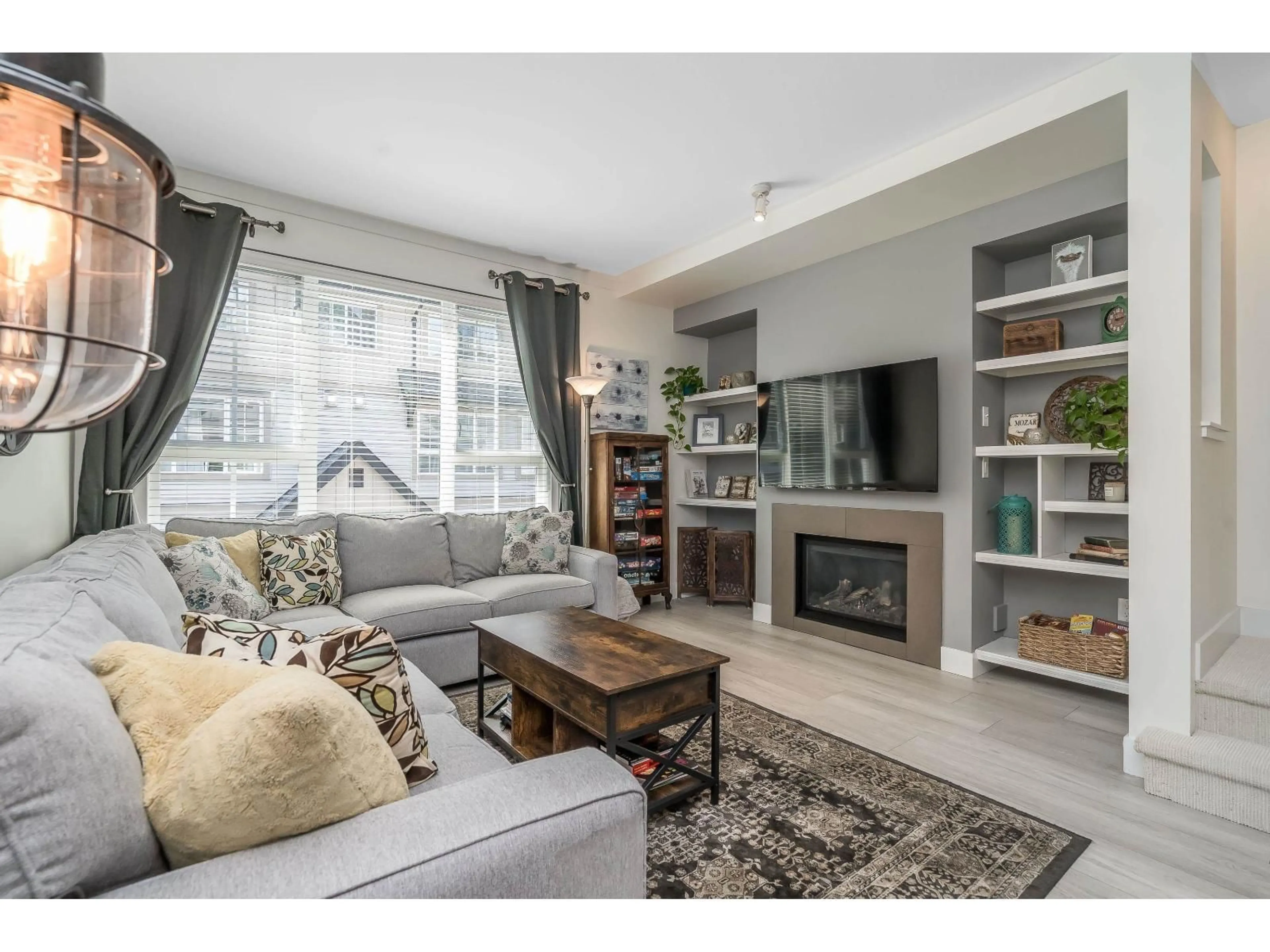 Living room with furniture, wood/laminate floor for 117 - 2501 161A STREET, Surrey British Columbia V3Z7Y6