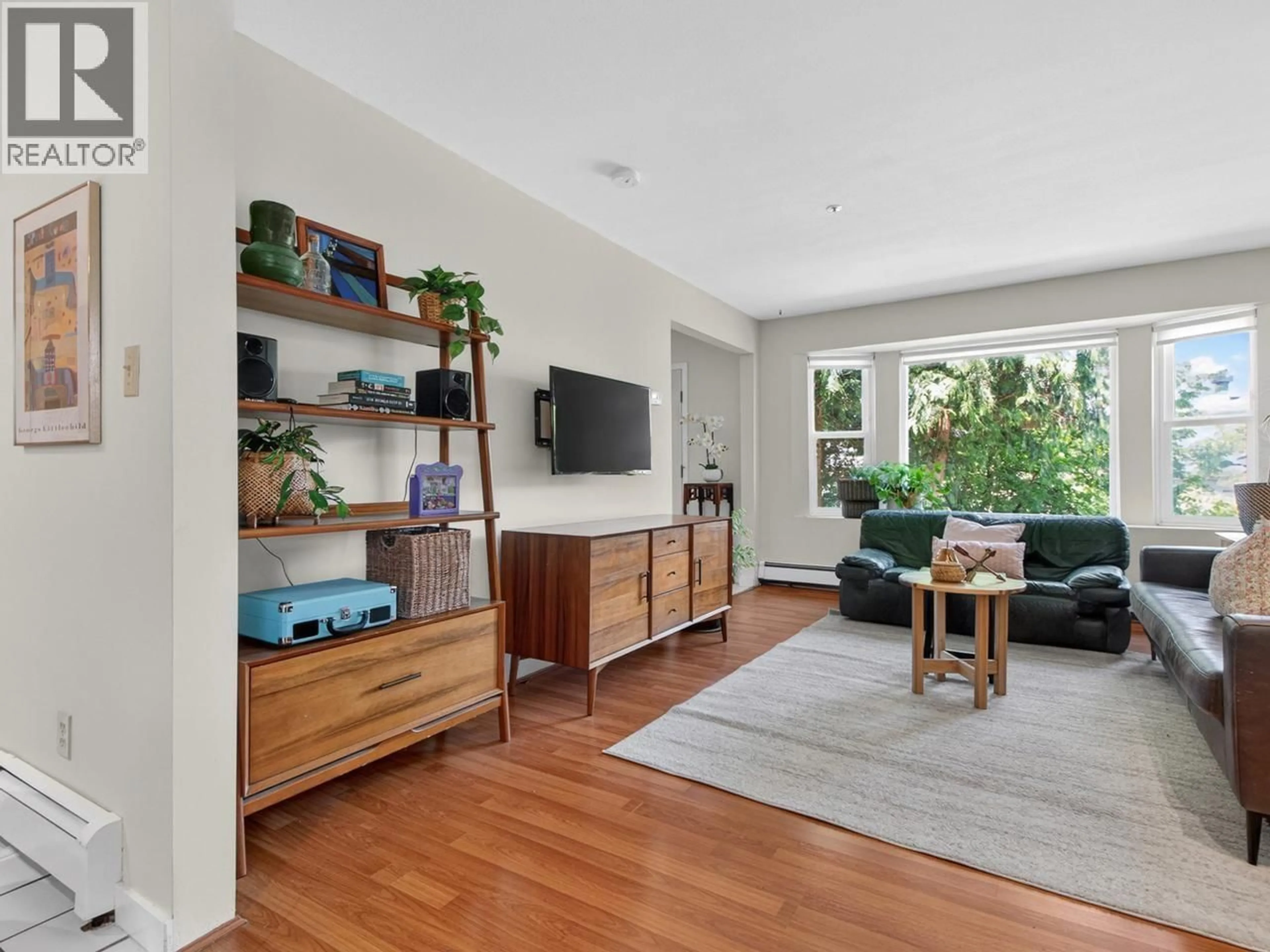 Living room with furniture, wood/laminate floor for 2128 ADANAC STREET, Vancouver British Columbia V5L2E7