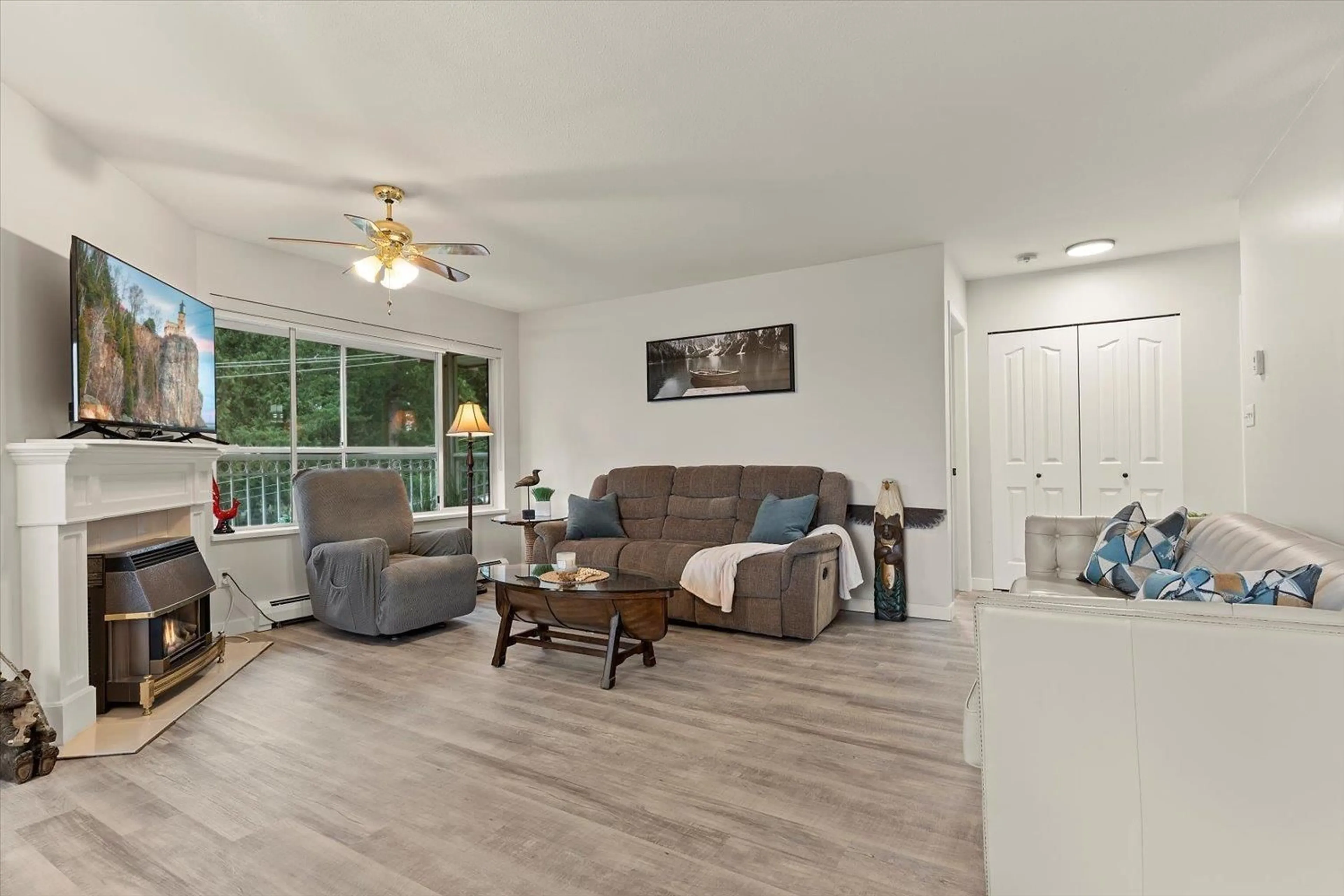 Living room with furniture, wood/laminate floor for 307 - 2491 GLADWIN ROAD, Abbotsford British Columbia V2T3N8
