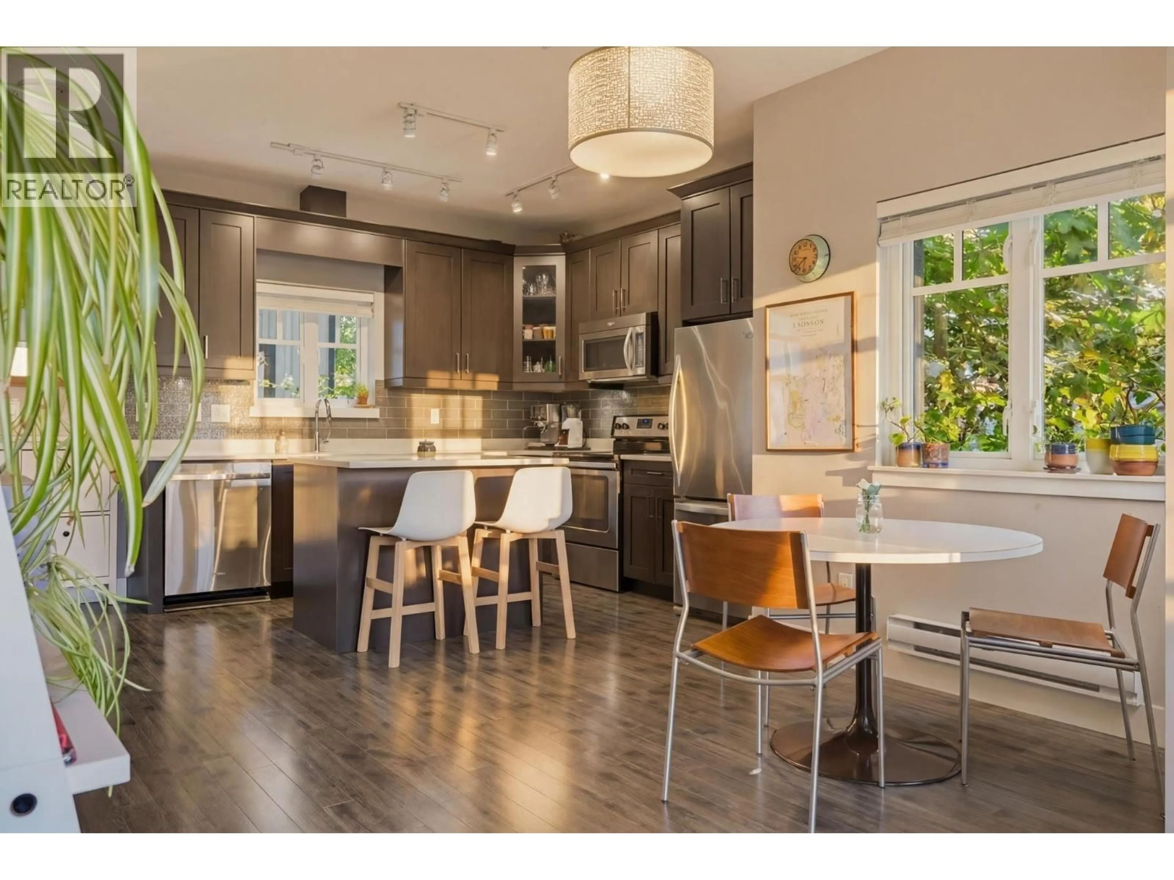 Open concept kitchen, wood/laminate floor for 215 - 2273 TRIUMPH STREET, Vancouver British Columbia V5L1L2