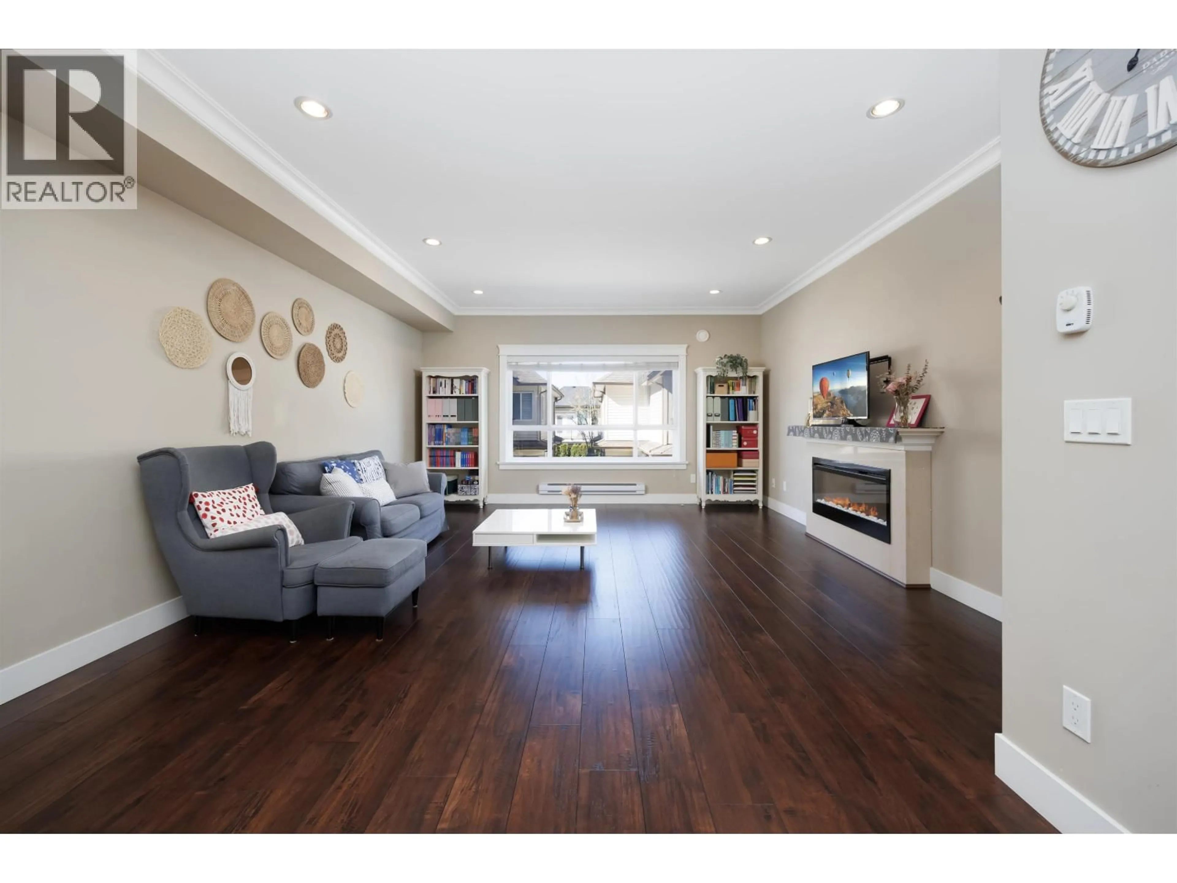 Living room with furniture, wood/laminate floor for 13 - 7551 NO. 2 ROAD, Richmond British Columbia V7L3L7