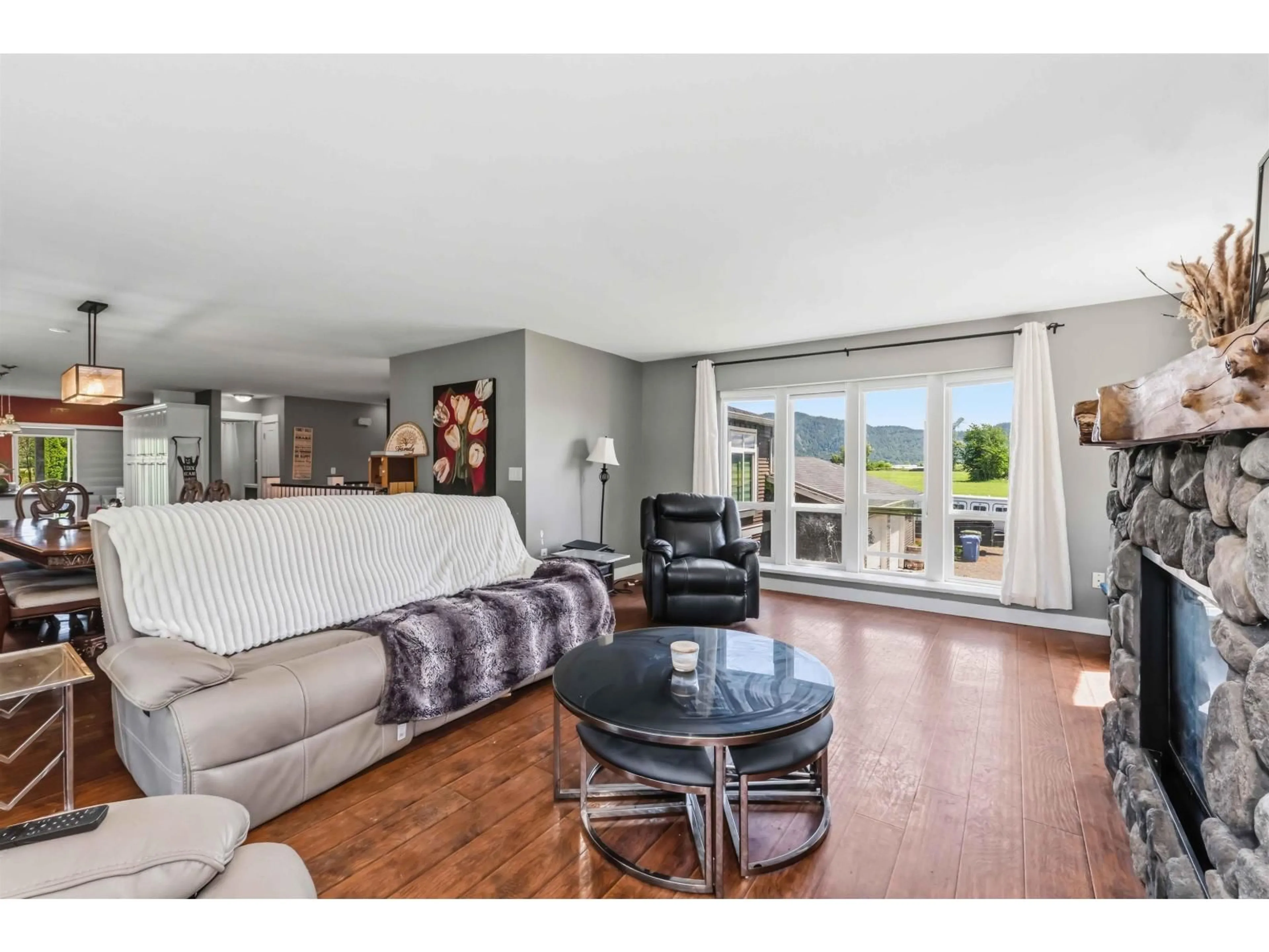 Living room with furniture, wood/laminate floor for 7310 KELLEHER STREET, Abbotsford British Columbia V3G1N2