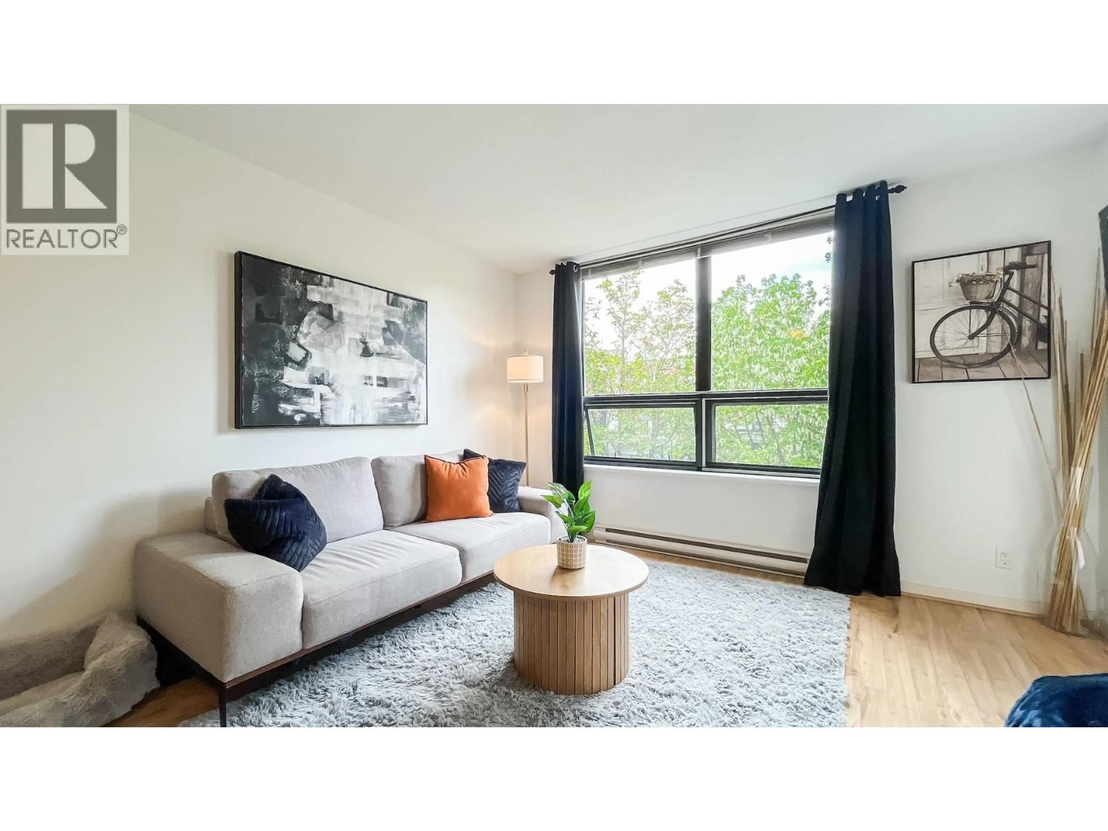 Living room with furniture, wood/laminate floor for 305 - 3638 VANNESS AVENUE, Vancouver British Columbia V5R6H6