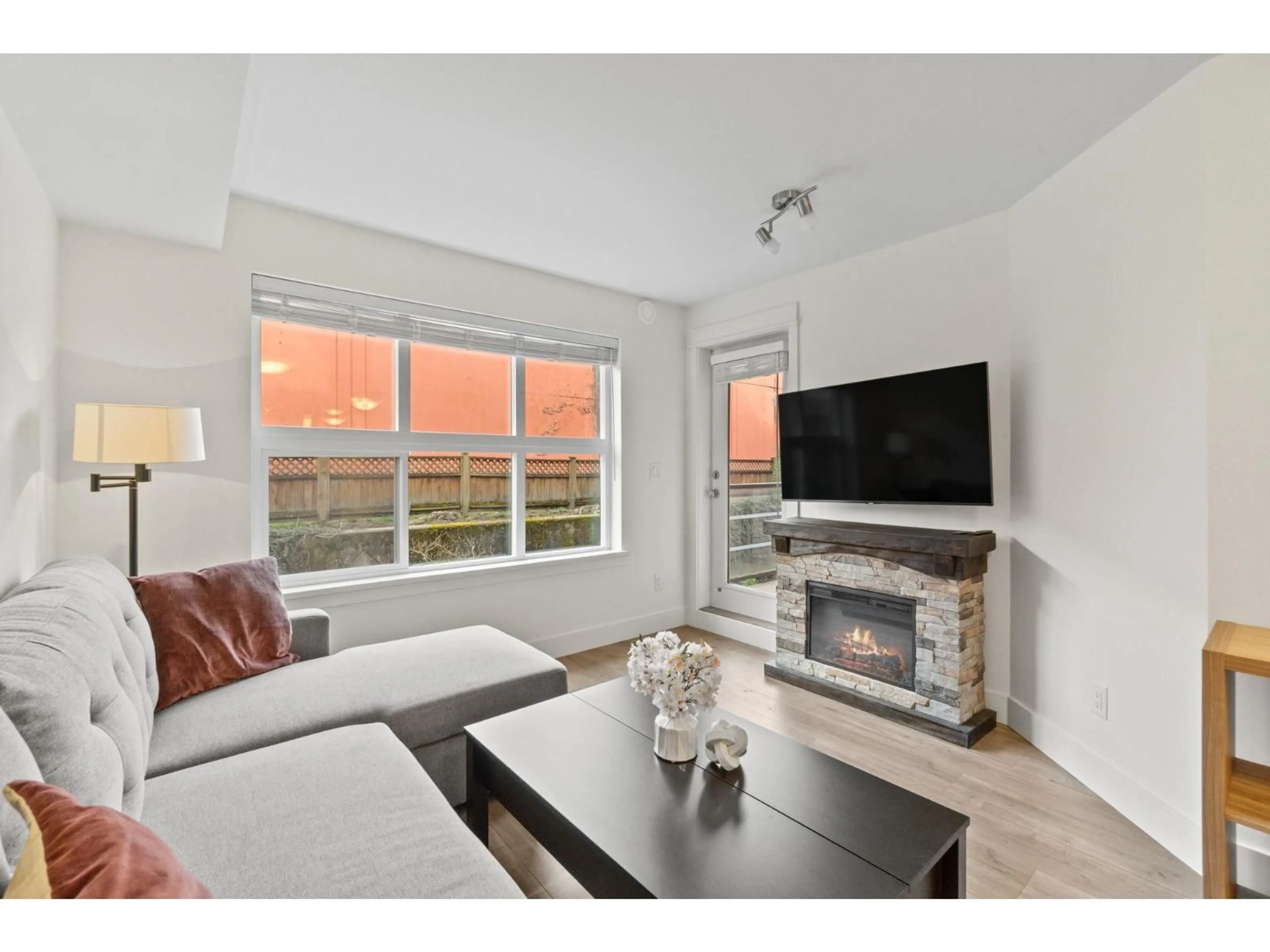 Living room with furniture, wood/laminate floor for 210 - 30515 CARDINAL AVENUE, Abbotsford British Columbia V2T0A8