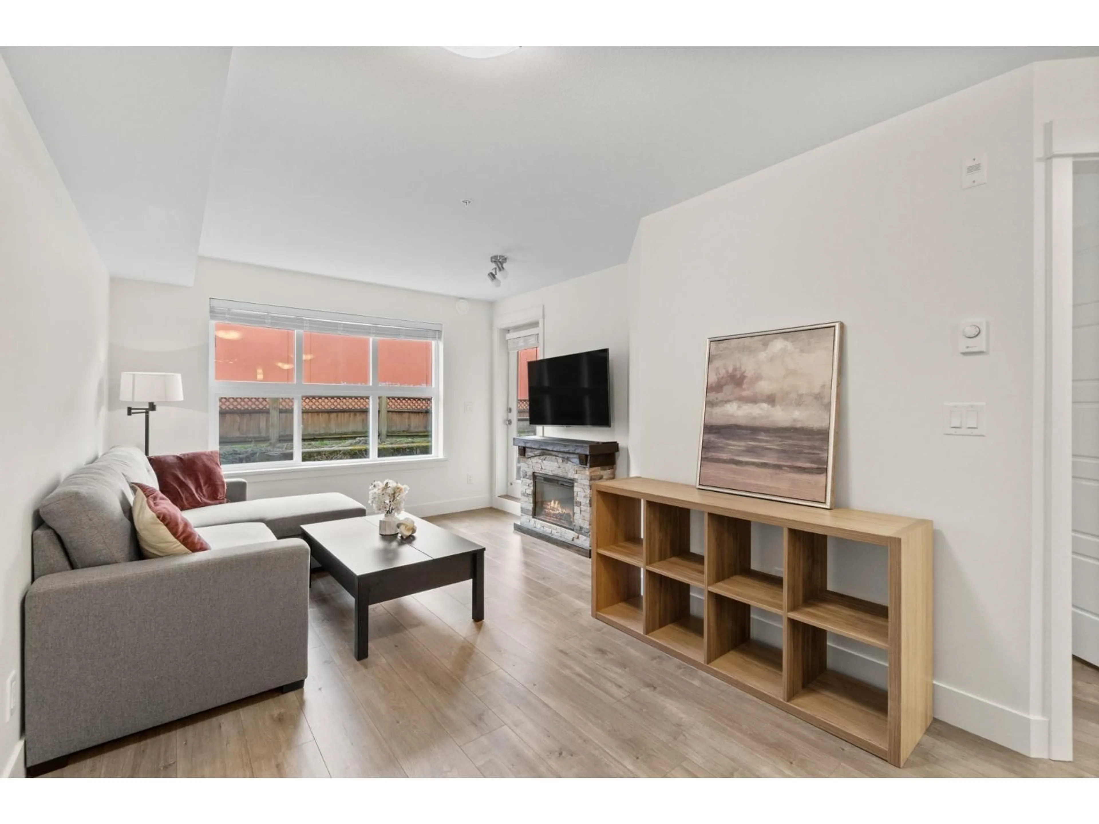 Living room with furniture, wood/laminate floor for 210 - 30515 CARDINAL AVENUE, Abbotsford British Columbia V2T0A8