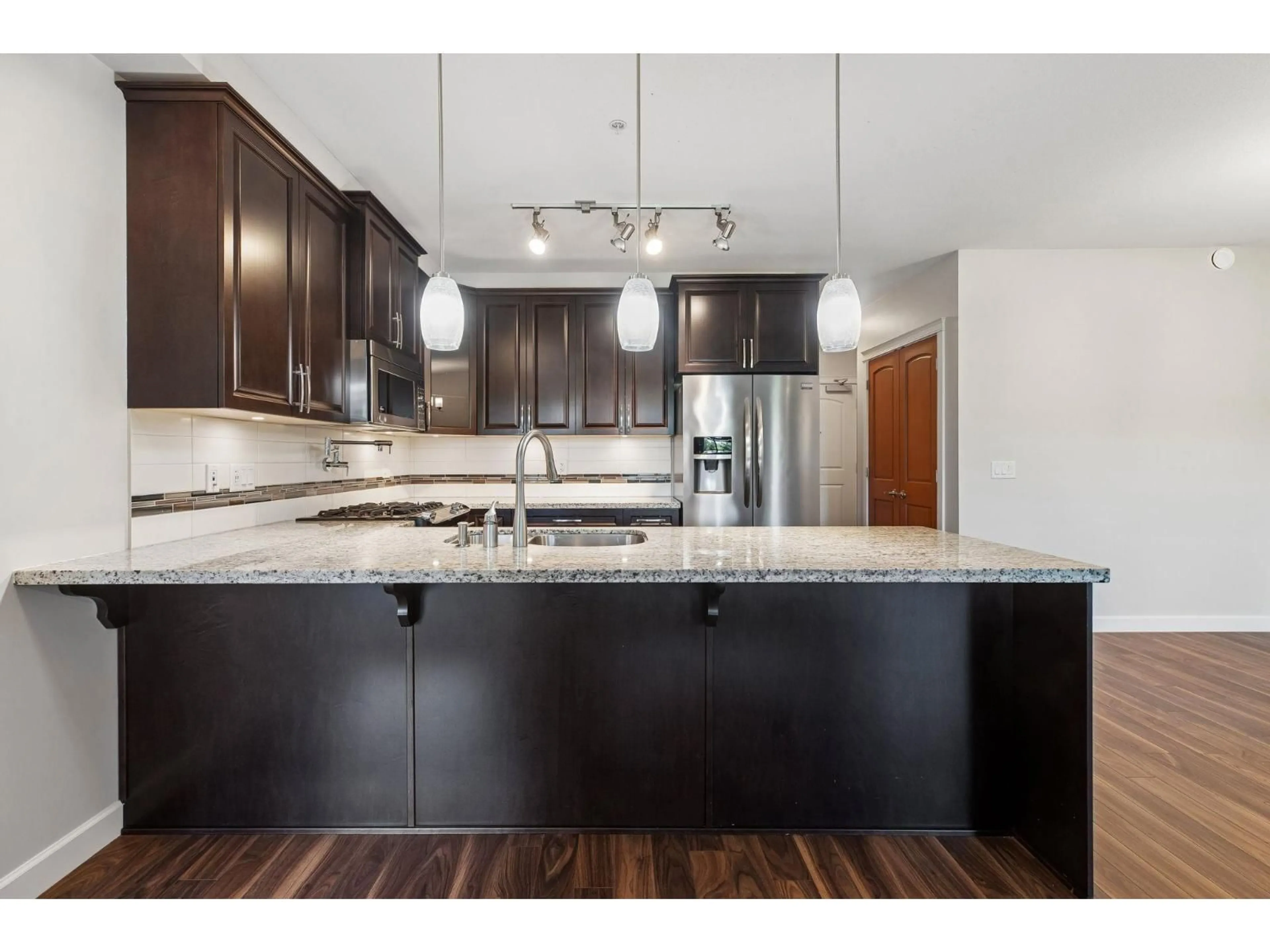 Open concept kitchen, wood/laminate floor for 228 - 8157 207 STREET, Surrey British Columbia V2Y0V3