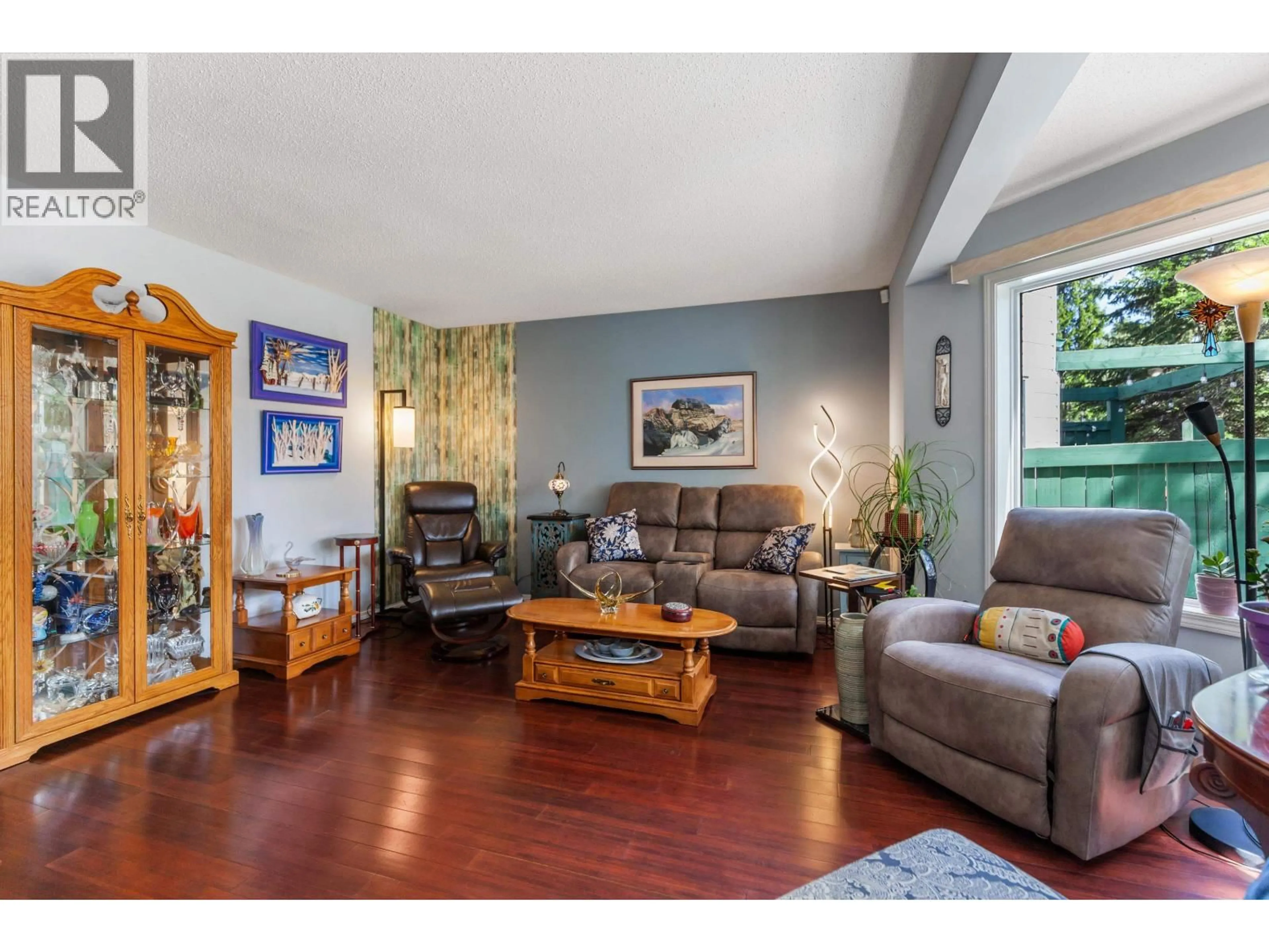 Living room with furniture, wood/laminate floor for 103 - 3233 MCGILL CRESCENT, Prince George British Columbia V2N2T4