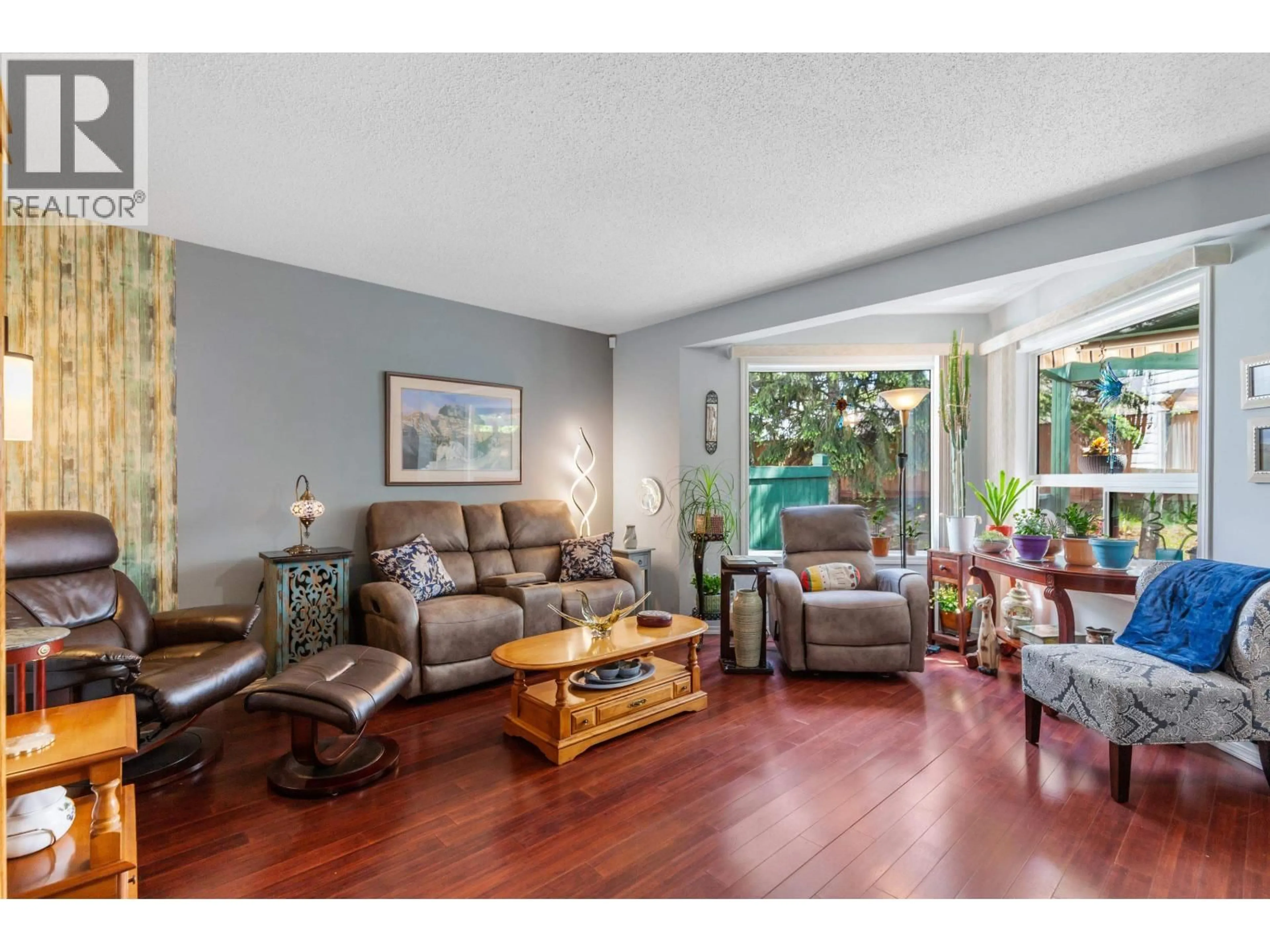 Living room with furniture, wood/laminate floor for 103 - 3233 MCGILL CRESCENT, Prince George British Columbia V2N2T4