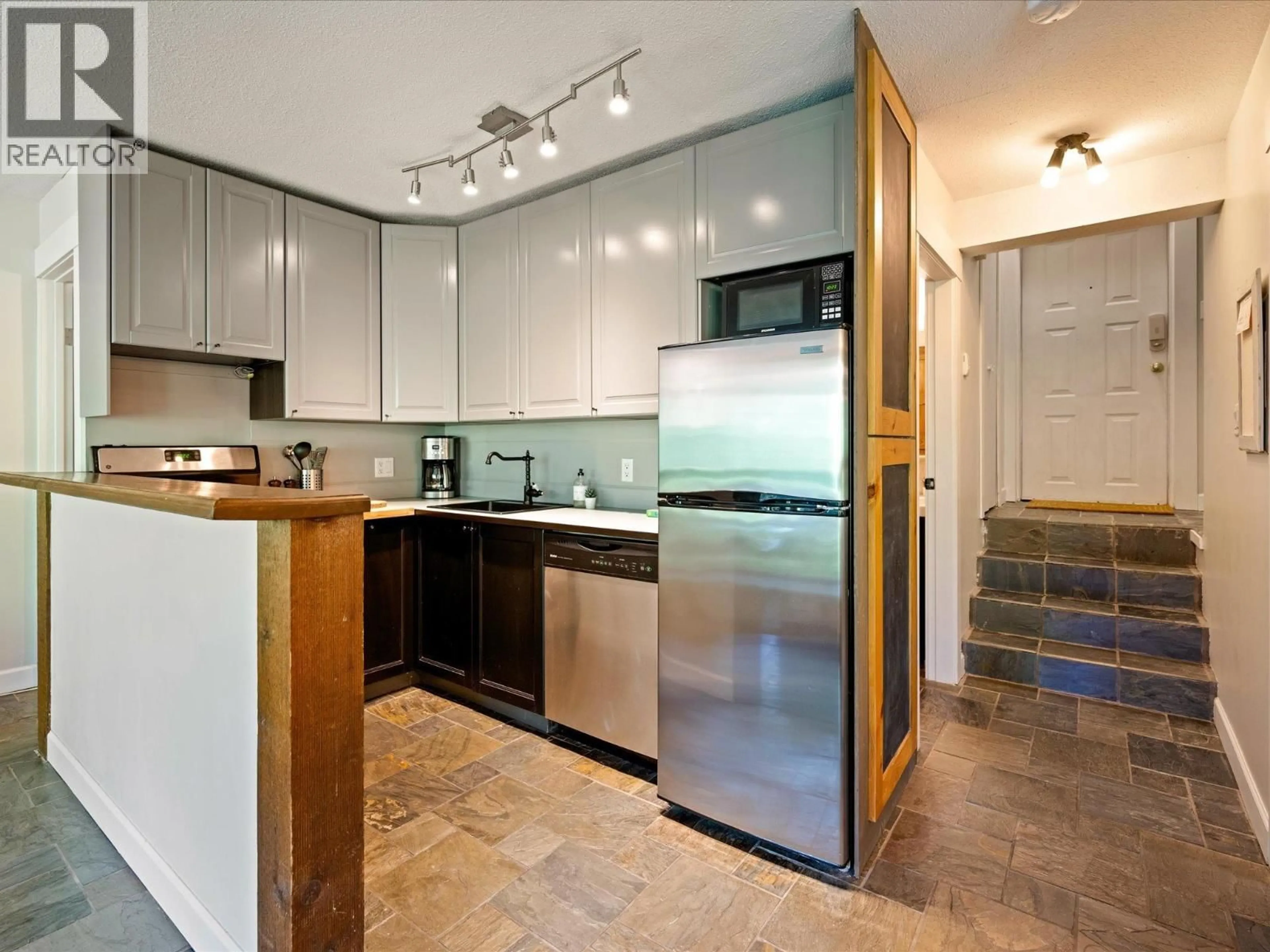 Contemporary kitchen, ceramic/tile floor for 1 - 2240 GONDOLA WAY, Whistler British Columbia V8E0N1