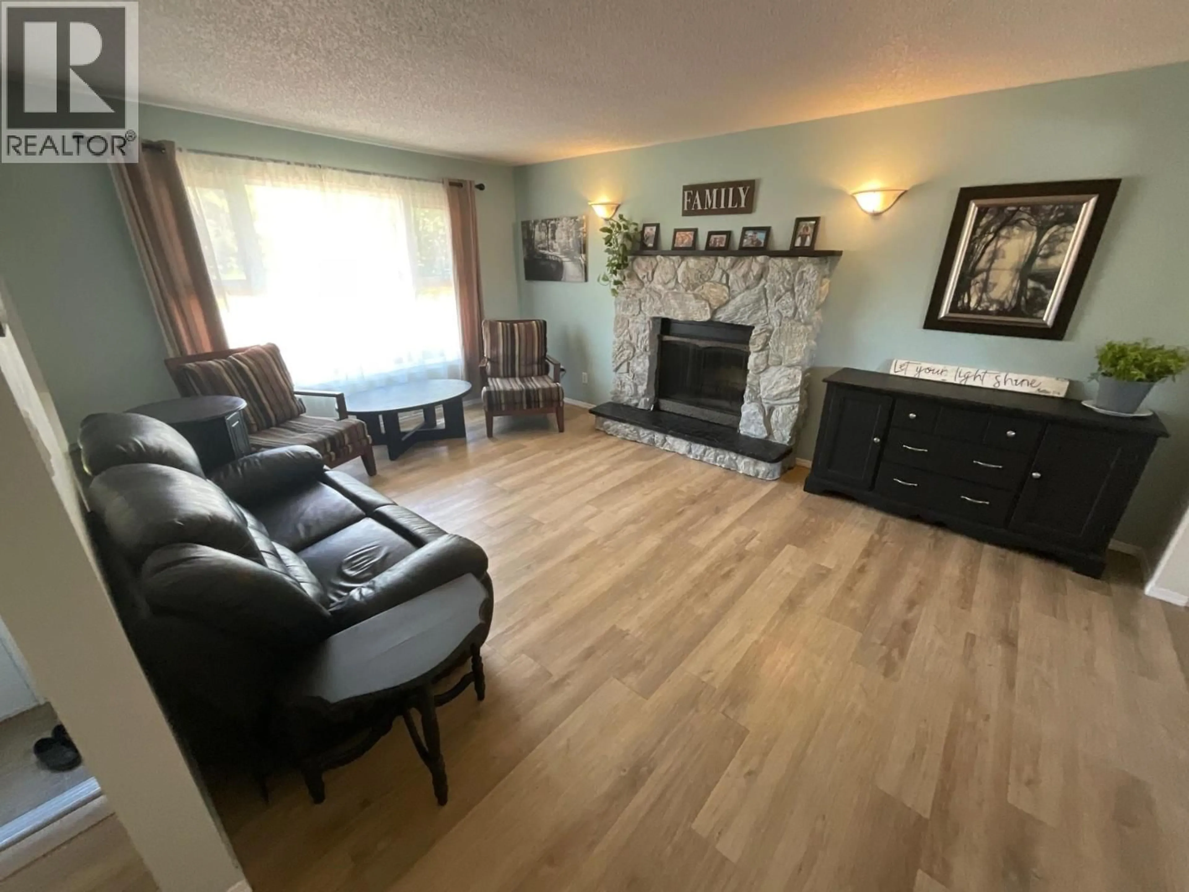 Living room with furniture, wood/laminate floor for 8812 87 STREET, Fort St. John British Columbia V1J5H6