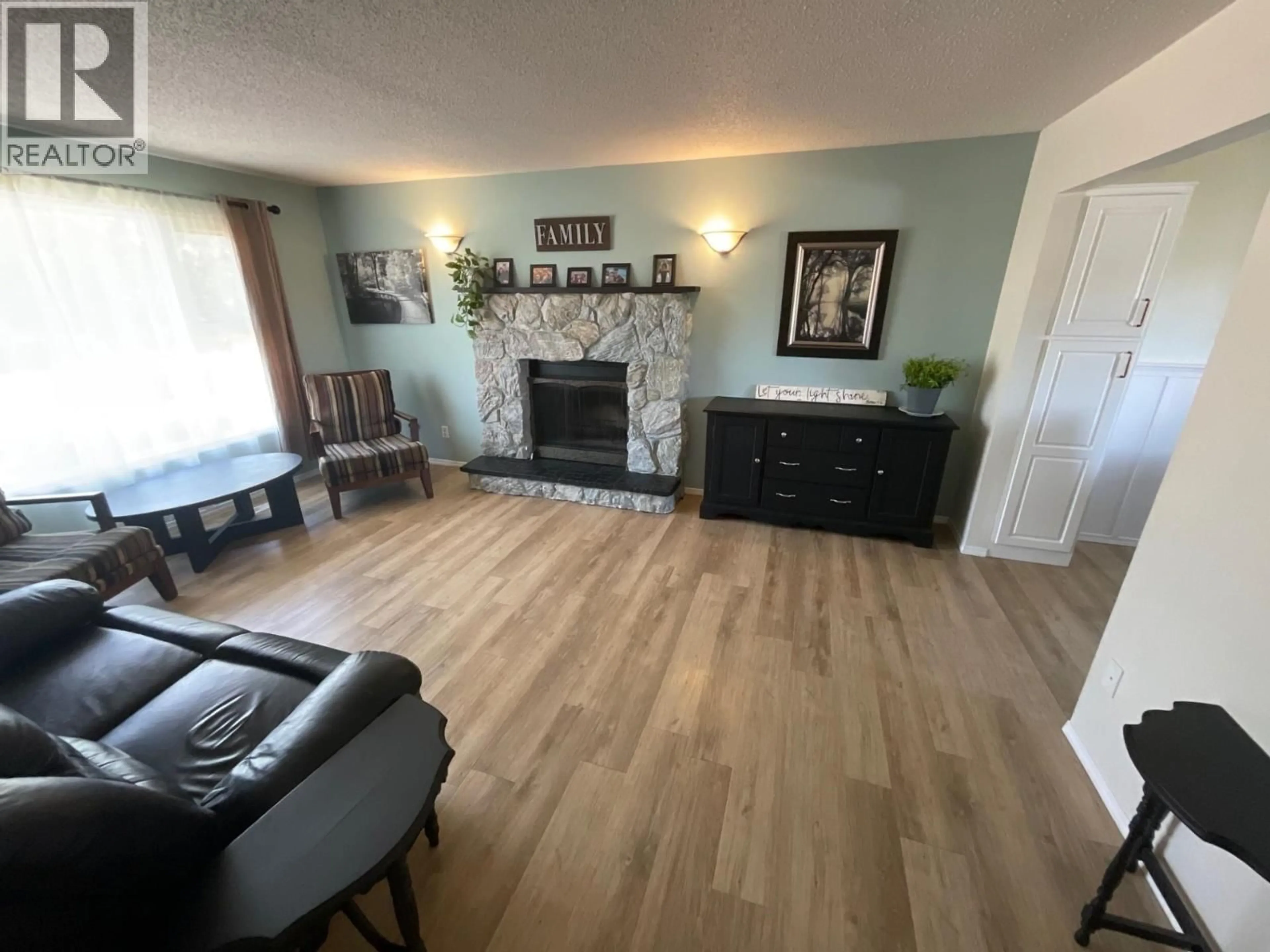 Living room with furniture, wood/laminate floor for 8812 87 STREET, Fort St. John British Columbia V1J5H6