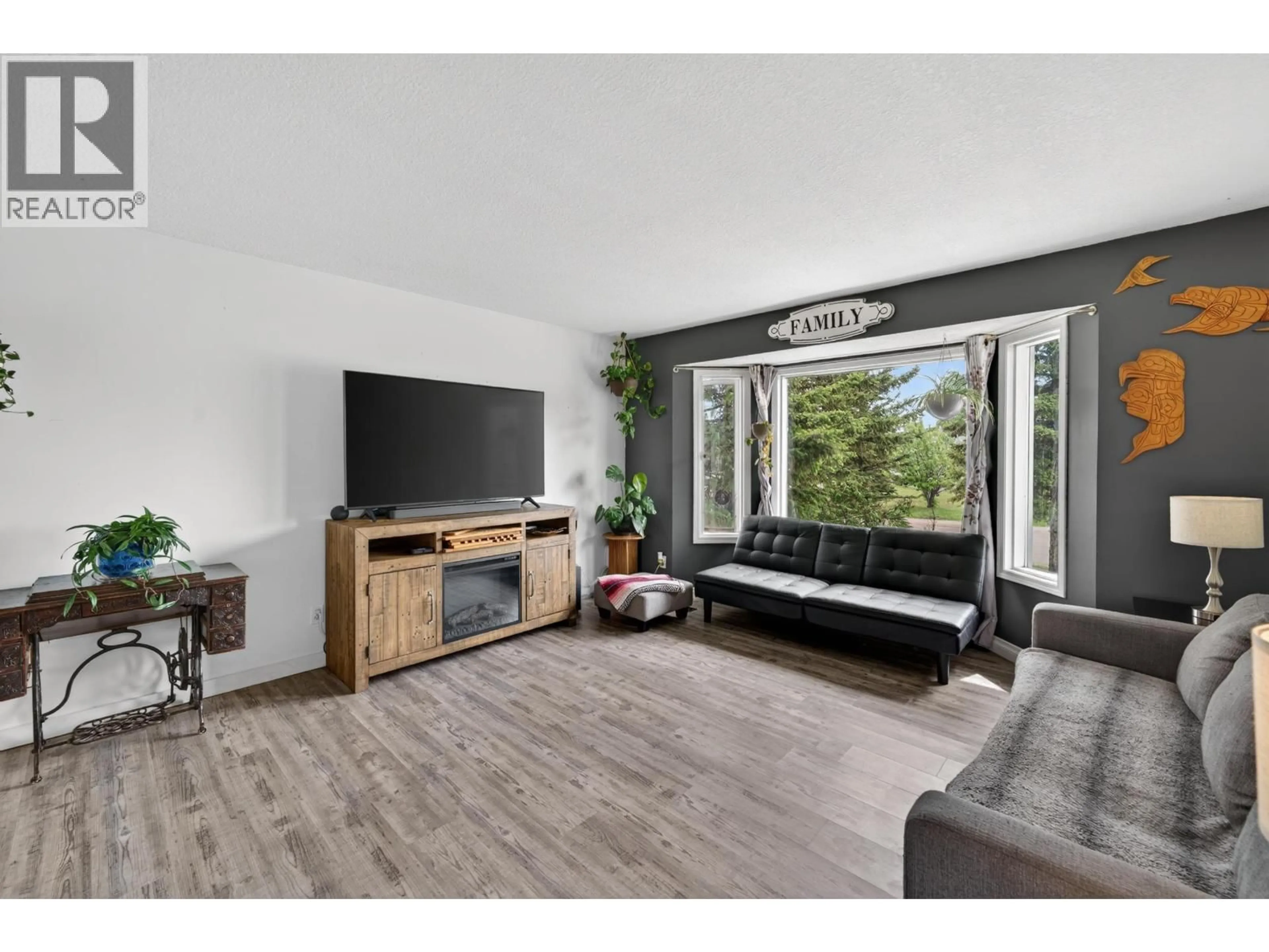 Living room with furniture, wood/laminate floor for 8208 98 AVENUE, Fort St. John British Columbia V1J1P5