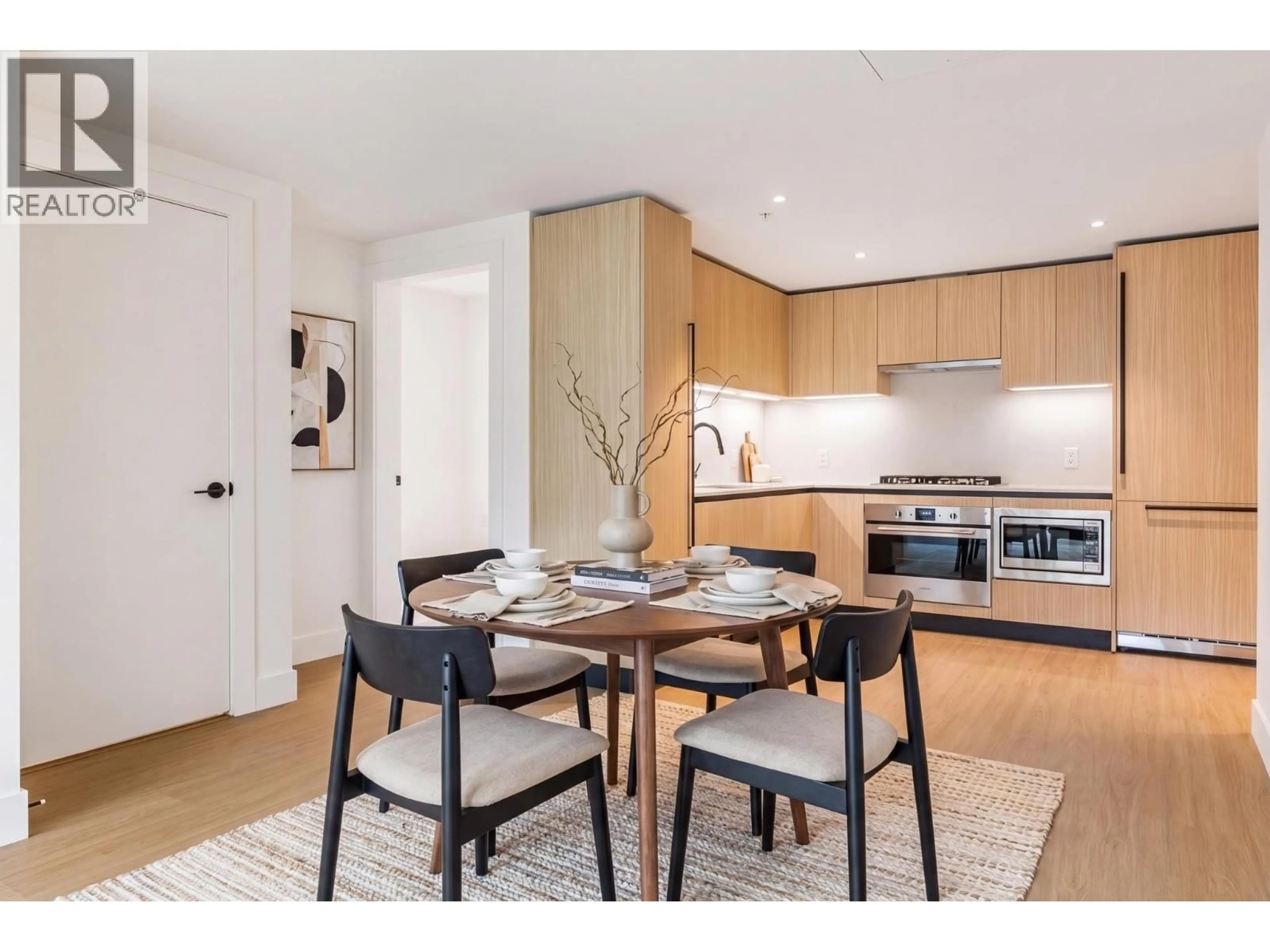 Open concept kitchen, wood/laminate floor for 202 - 2235 BROADWAY, Vancouver British Columbia V5N0J5