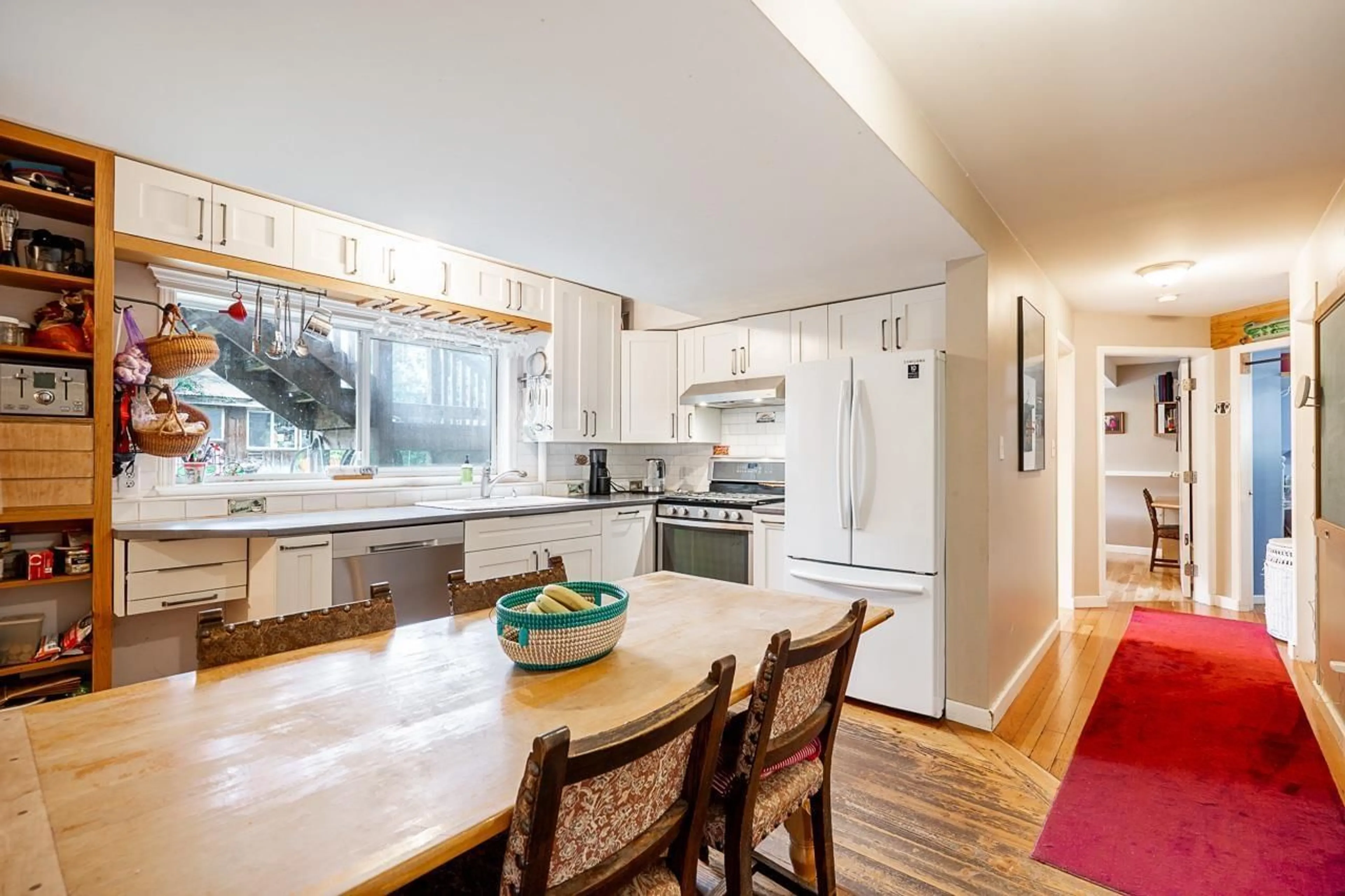 Open concept kitchen, wood/laminate floor for 15661 92 AVENUE, Surrey British Columbia V4N3C3