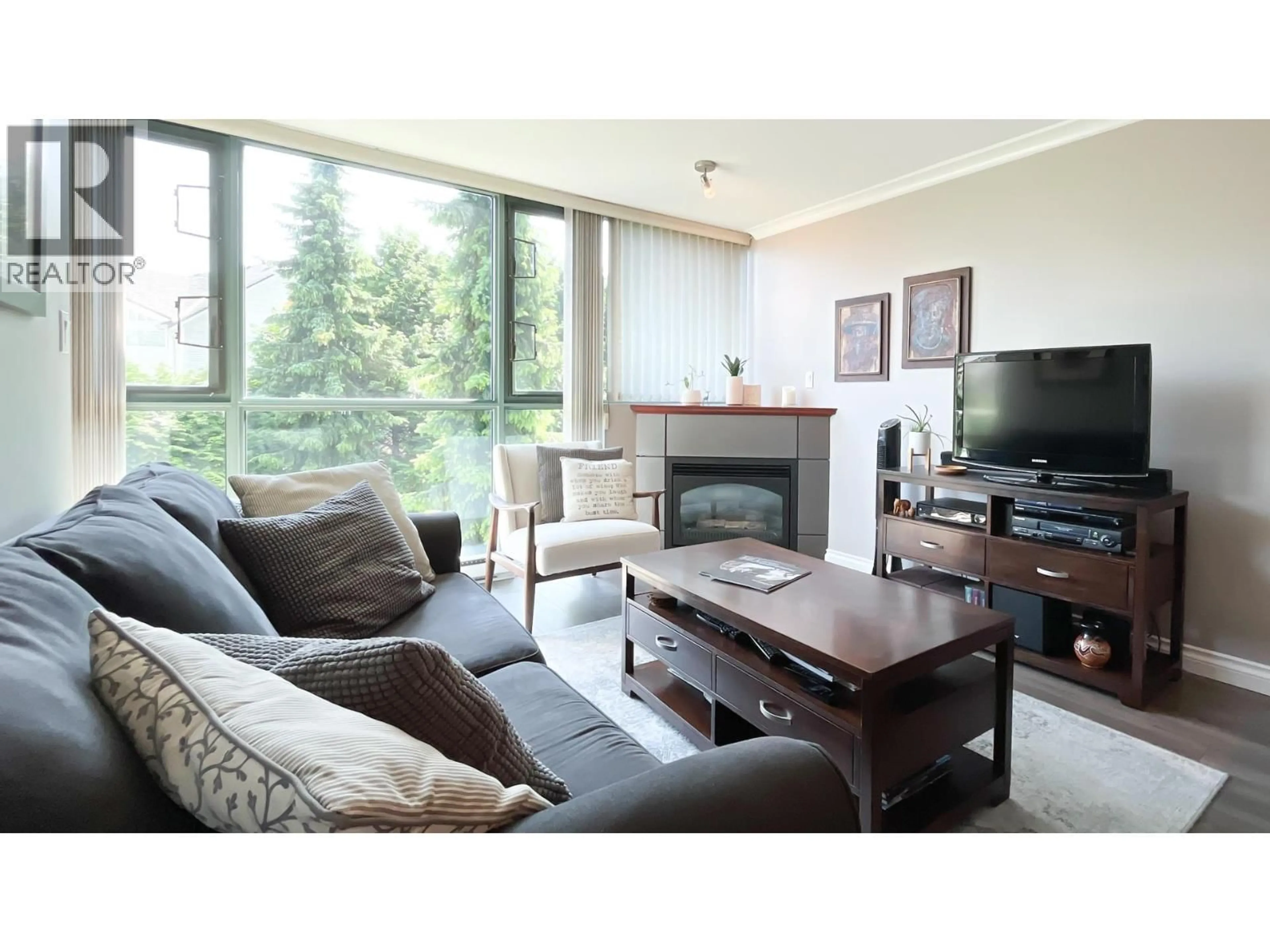 Living room with furniture, wood/laminate floor for 206 - 2733 CHANDLERY PLACE, Vancouver British Columbia V5S4V3