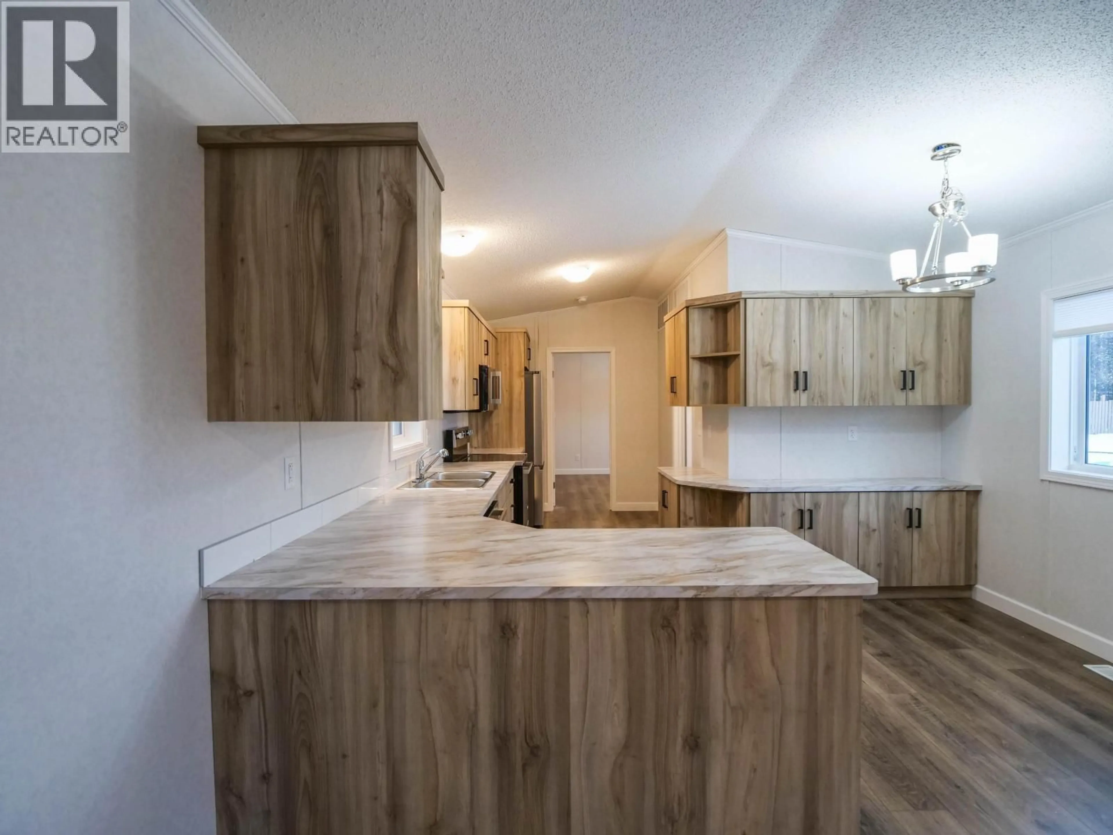 Open concept kitchen, wood/laminate floor for 41 - 602 ELM STREET, Quesnel British Columbia V3J3X1
