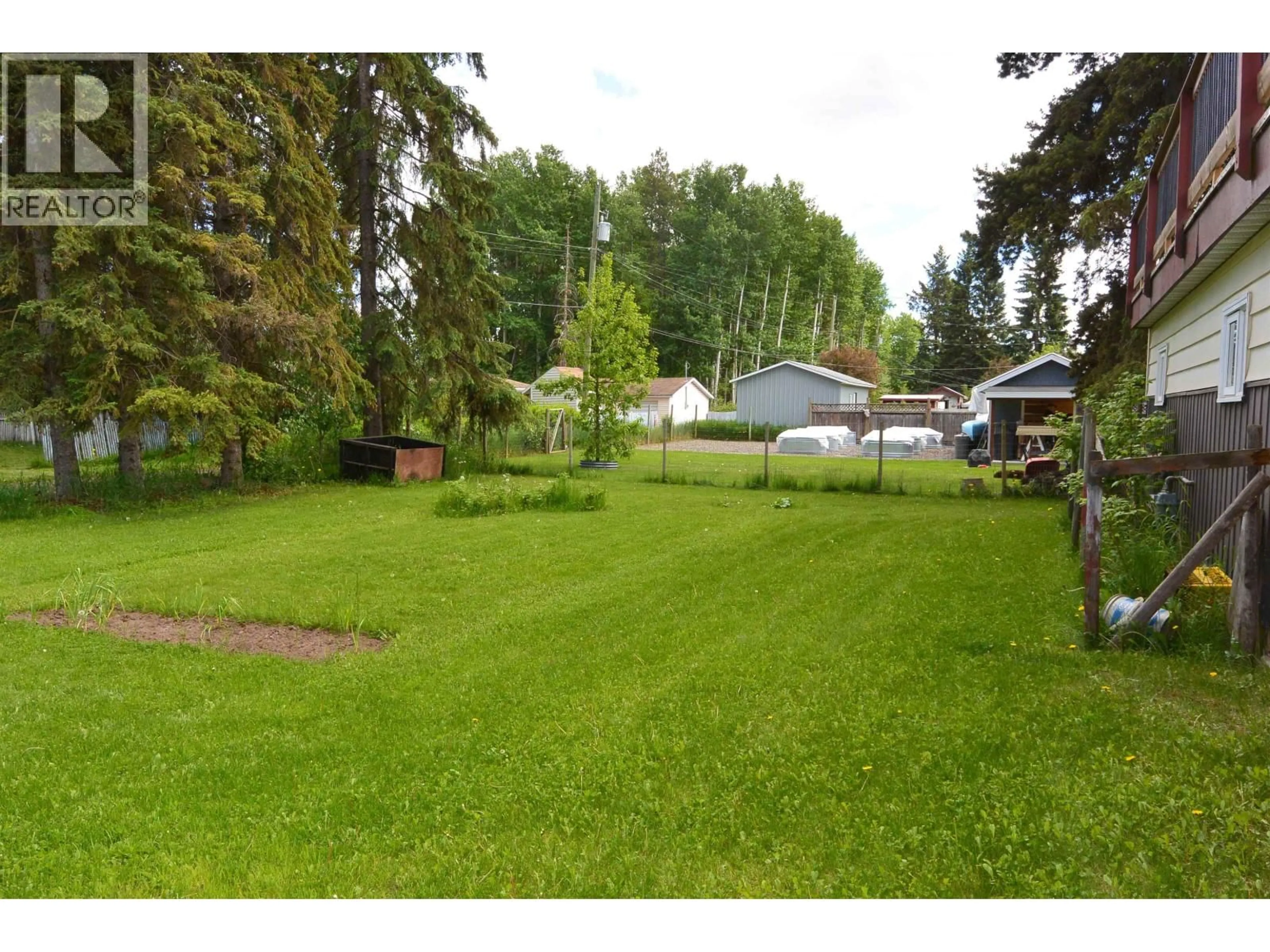 A pic from outside/outdoor area/front of a property/back of a property/a pic from drone, forest/trees view for 3592 FOURTH AVENUE, Smithers British Columbia V0J2N0
