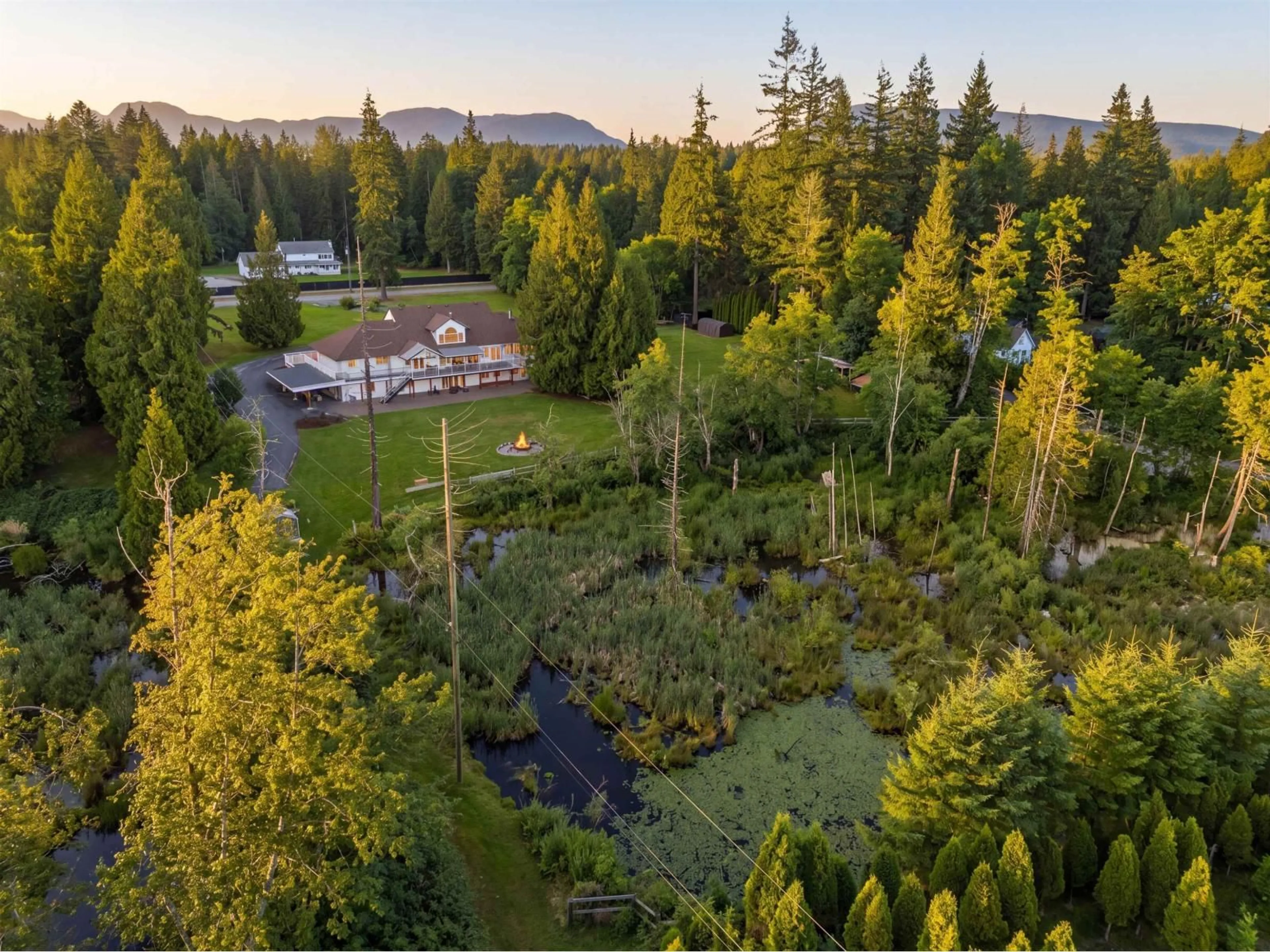 A pic from outside/outdoor area/front of a property/back of a property/a pic from drone, forest/trees view for 21980 100 AVENUE, Langley British Columbia V1M3V1