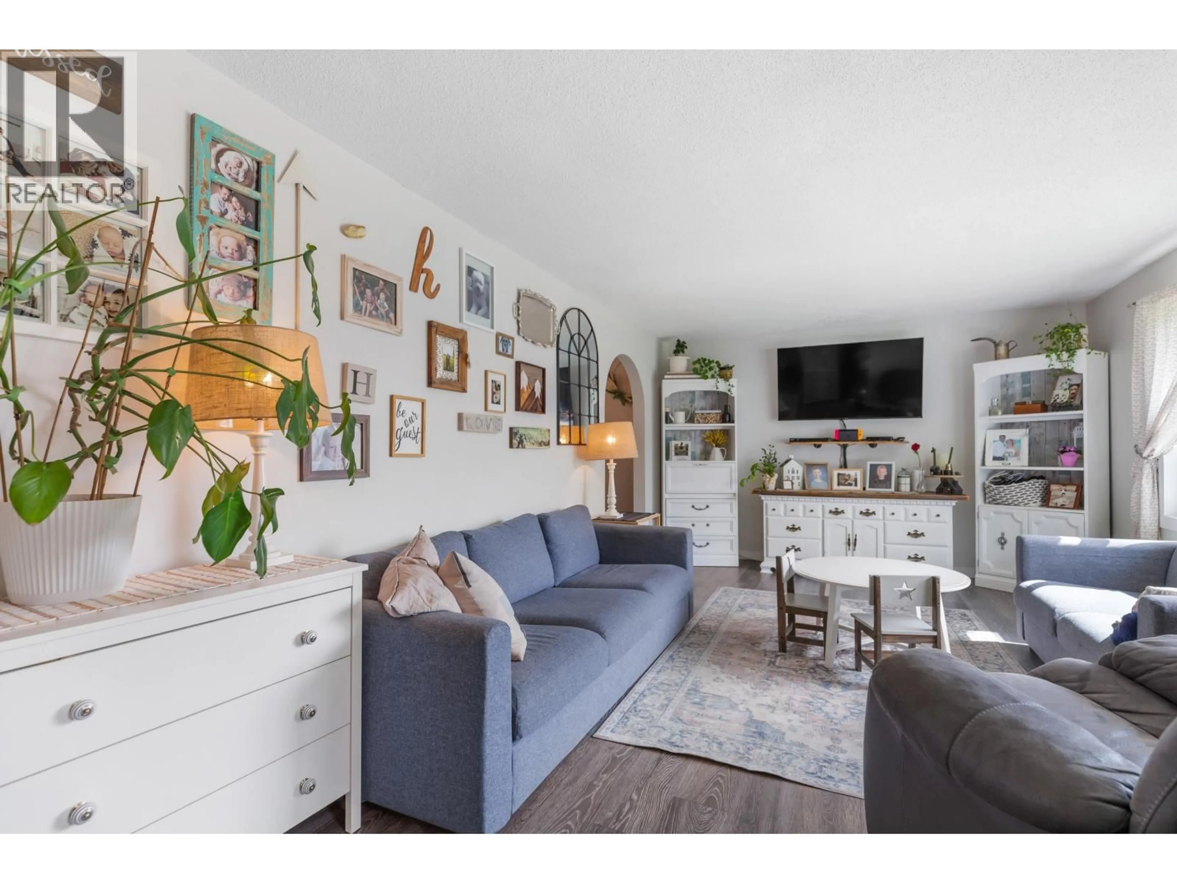 Living room with furniture, wood/laminate floor for 3908 ENEMARK CRESCENT, Prince George British Columbia V2N2X5