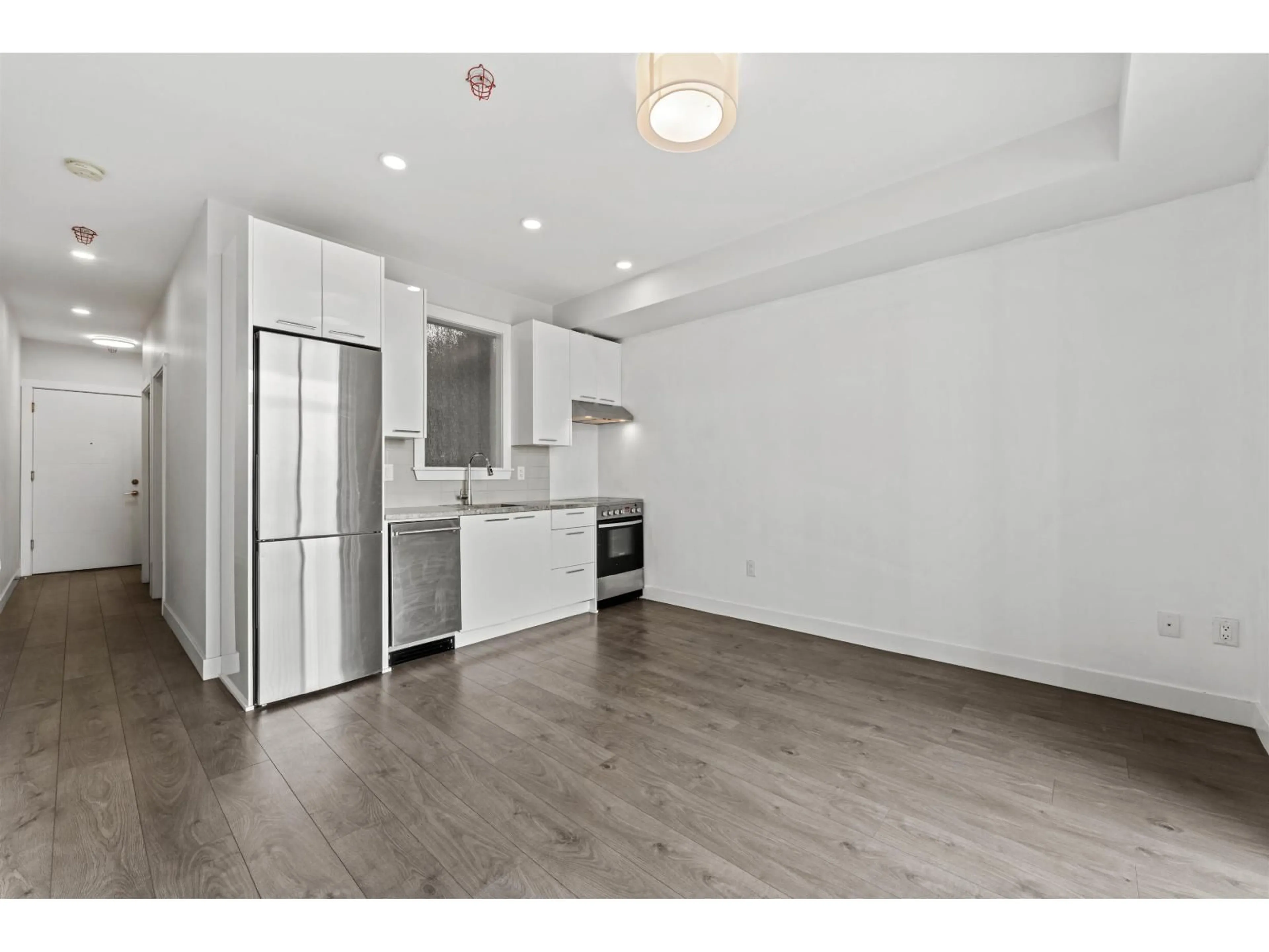 Open concept kitchen, wood/laminate floor for 305 - 20686 EASTLEIGH CRESCENT, Langley British Columbia V3A0M4