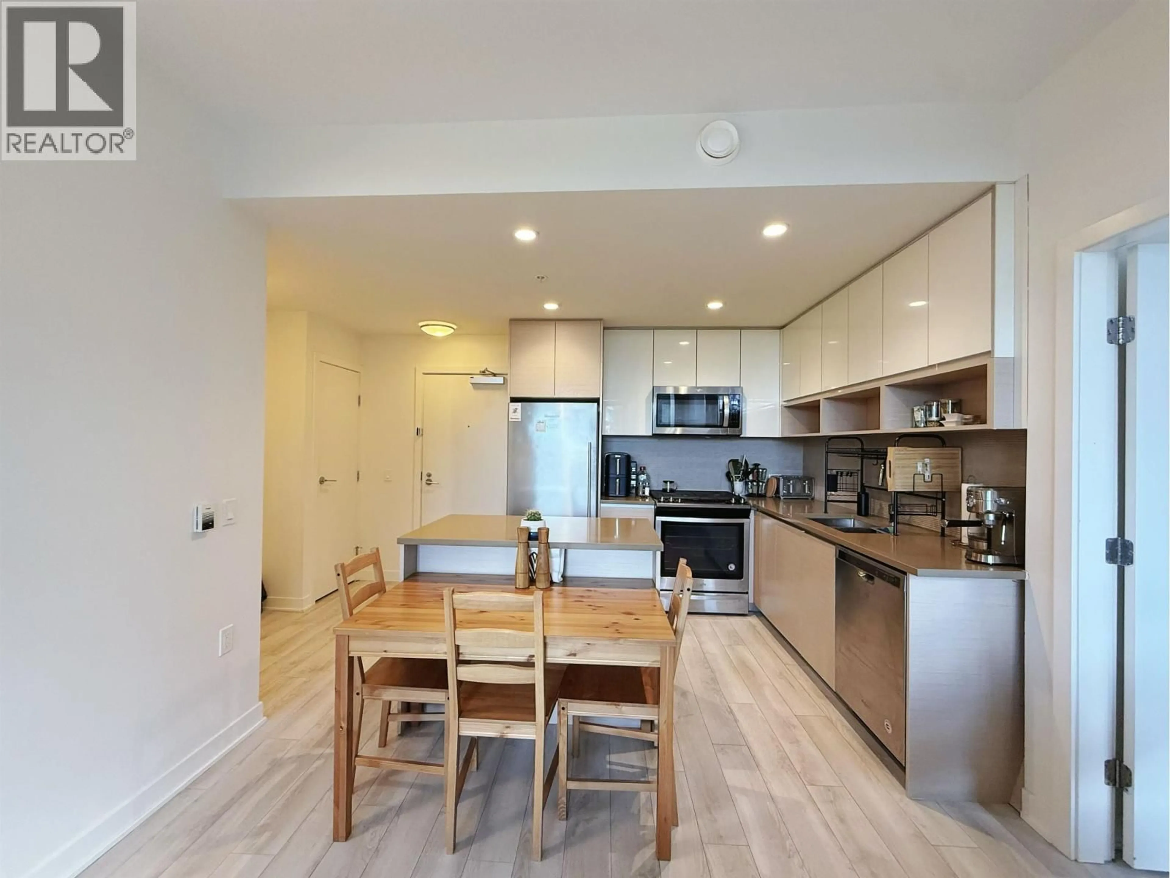 Open concept kitchen, wood/laminate floor for 105 - 8850 UNIVERSITY CRESCENT, Burnaby British Columbia V5A0C8