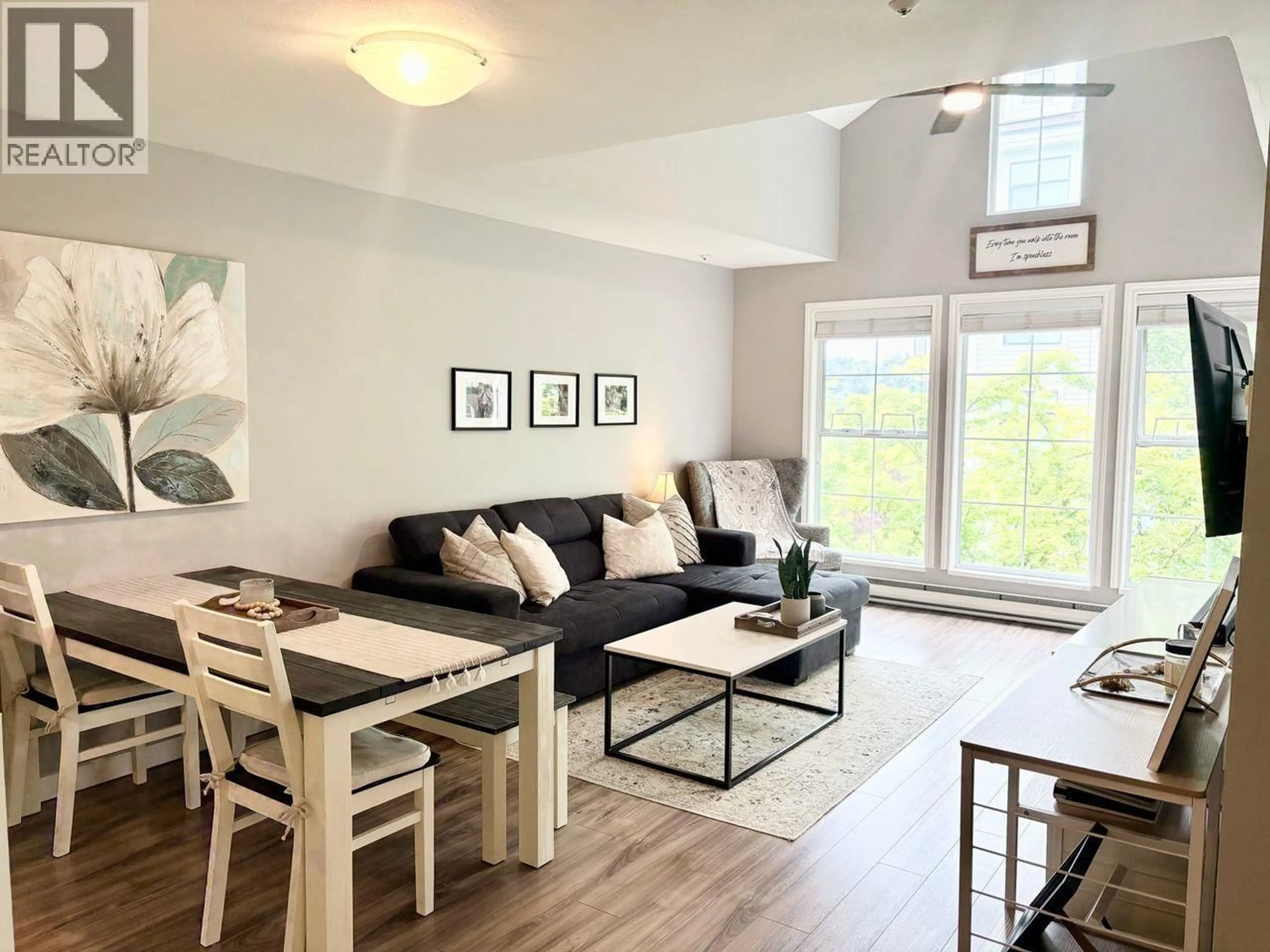 Living room with furniture, wood/laminate floor for 402 - 888 GAUTHIER AVENUE, Coquitlam British Columbia V3K6Y1