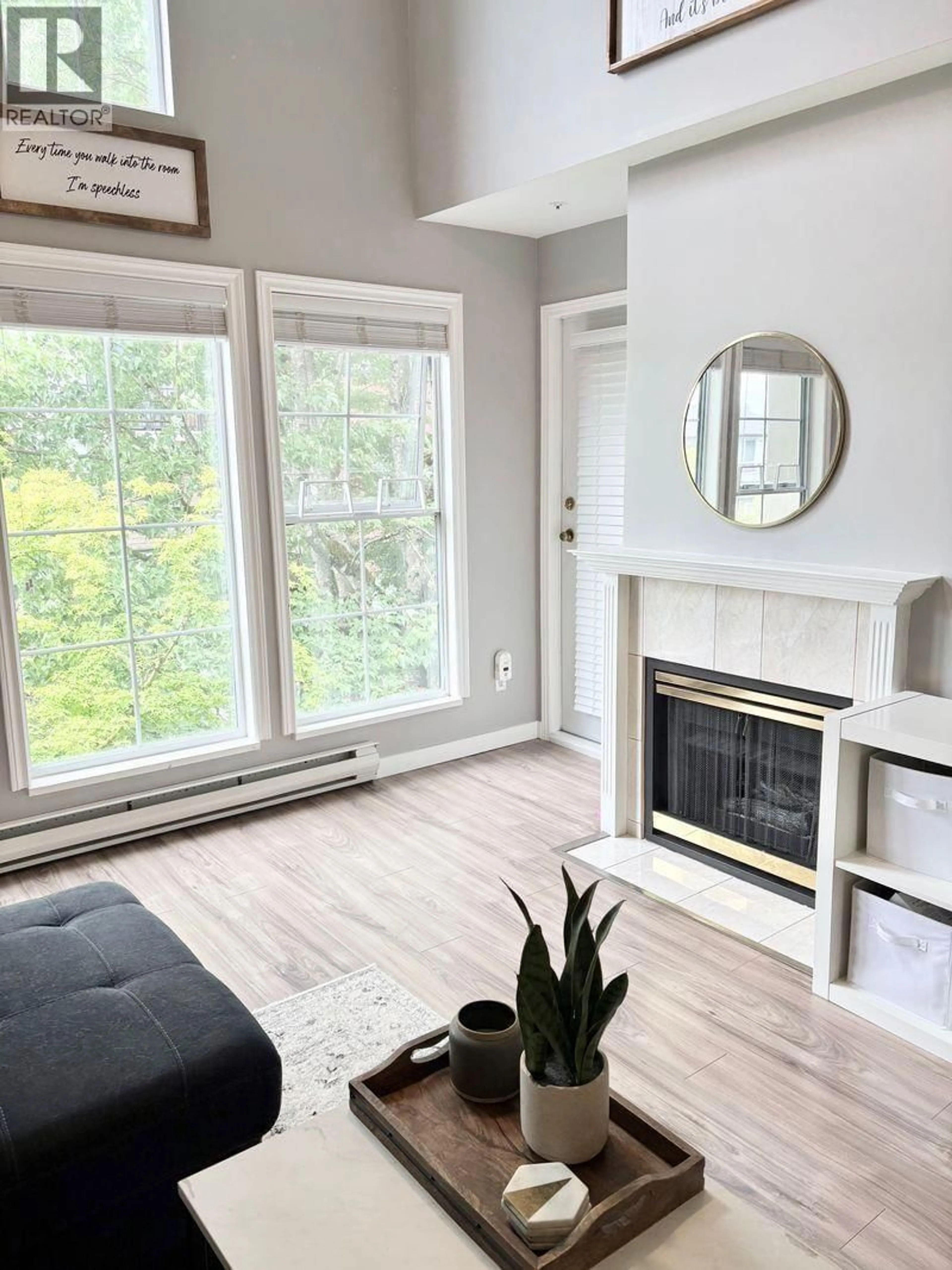 Living room with furniture, wood/laminate floor for 402 - 888 GAUTHIER AVENUE, Coquitlam British Columbia V3K6Y1