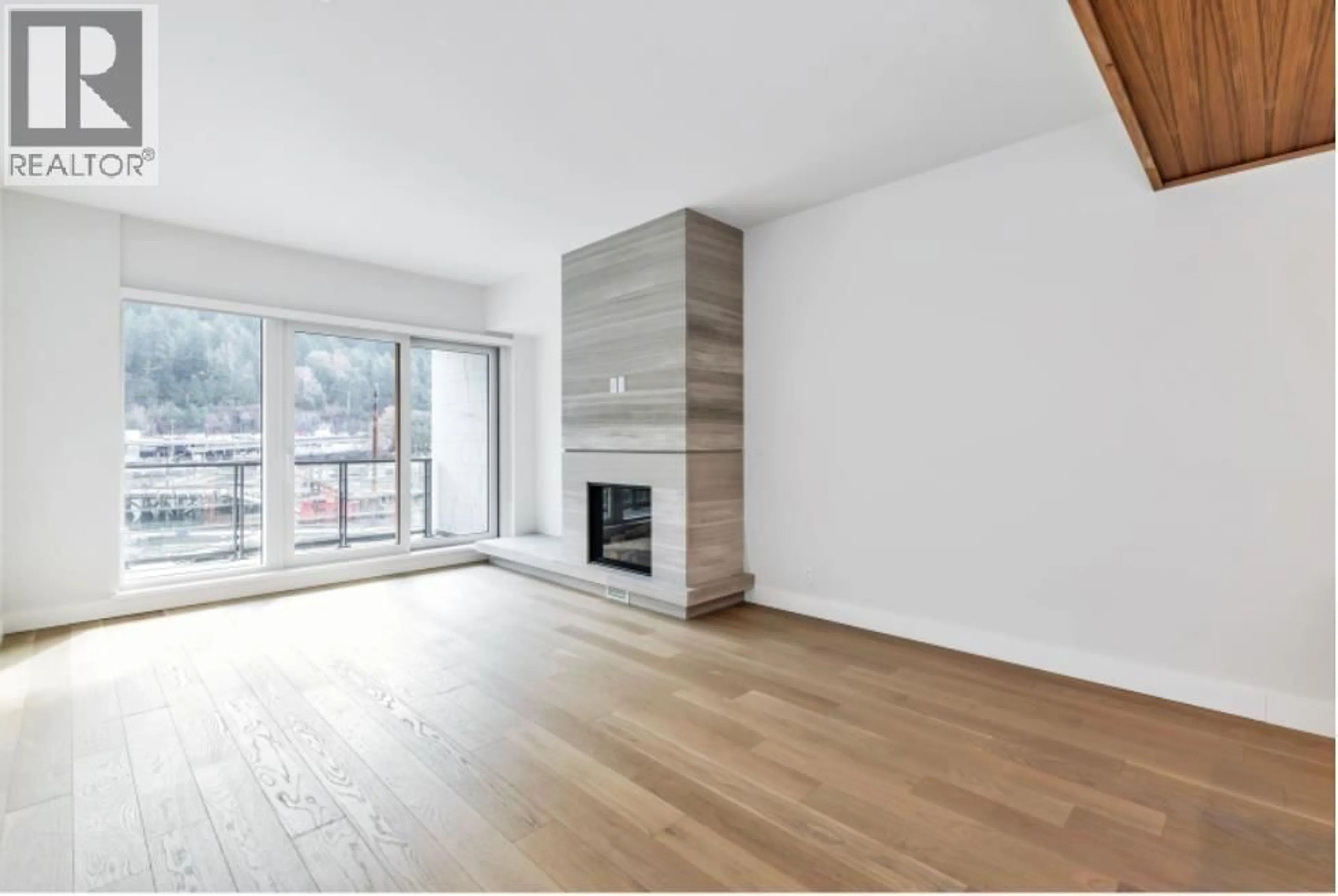 Living room with furniture, wood/laminate floor for 205 - 6707 NELSON AVENUE, West Vancouver British Columbia V7W0A4