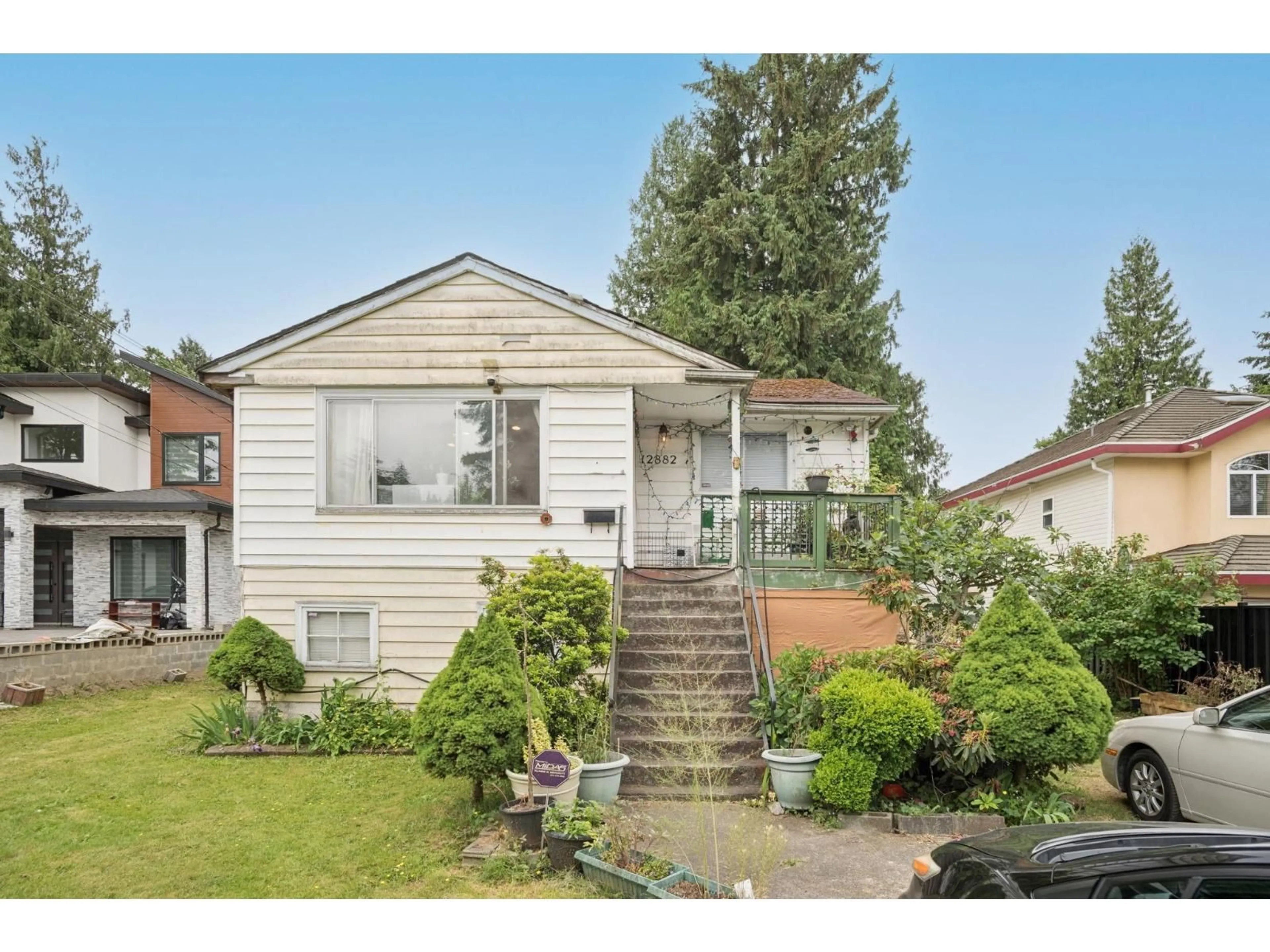 Home with vinyl exterior material, street for 12882 100 AVENUE, Surrey British Columbia V3T1G5