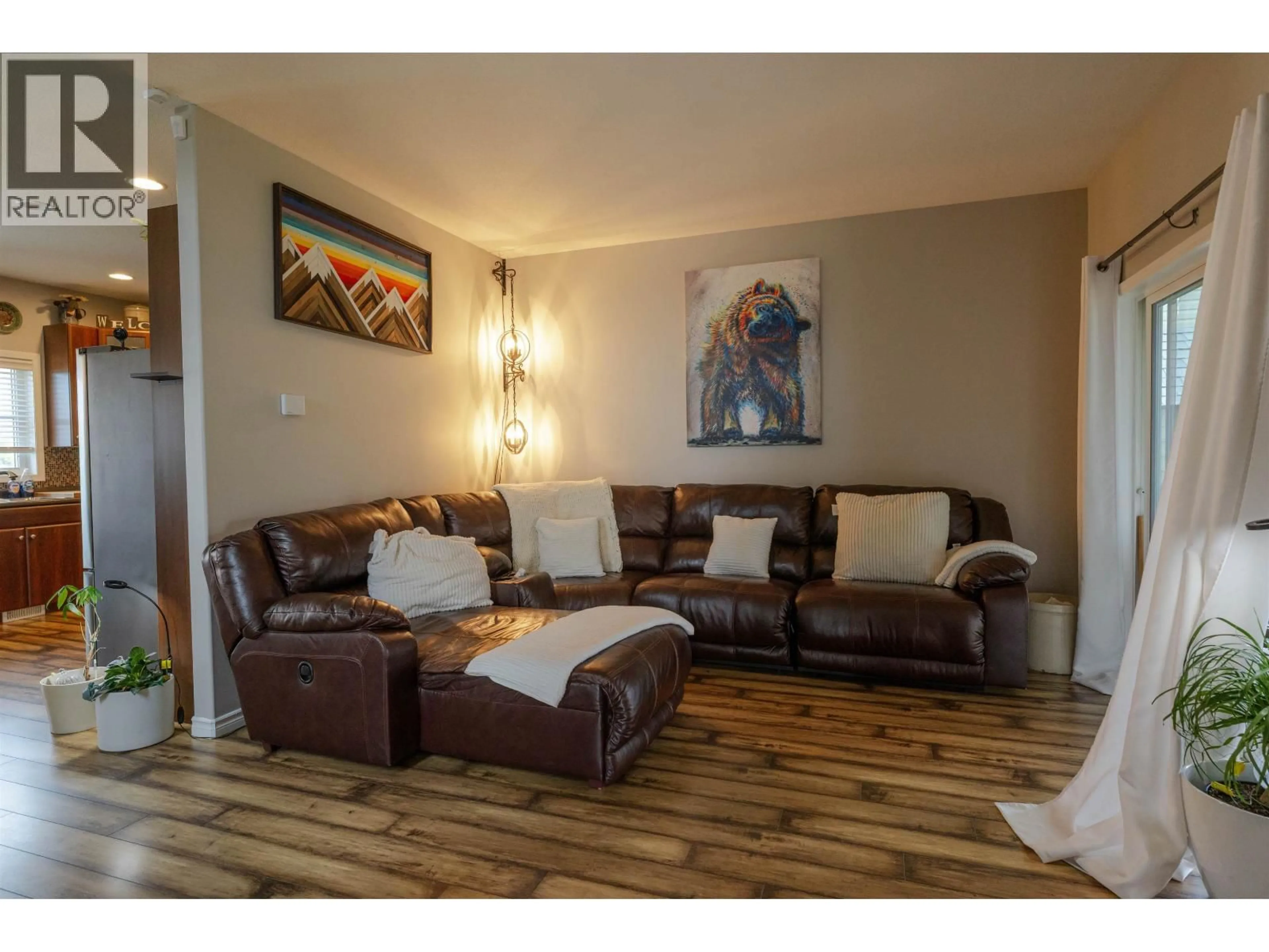 Living room with furniture, wood/laminate floor for 8803 113 AVENUE, Fort St. John British Columbia V1J0E2