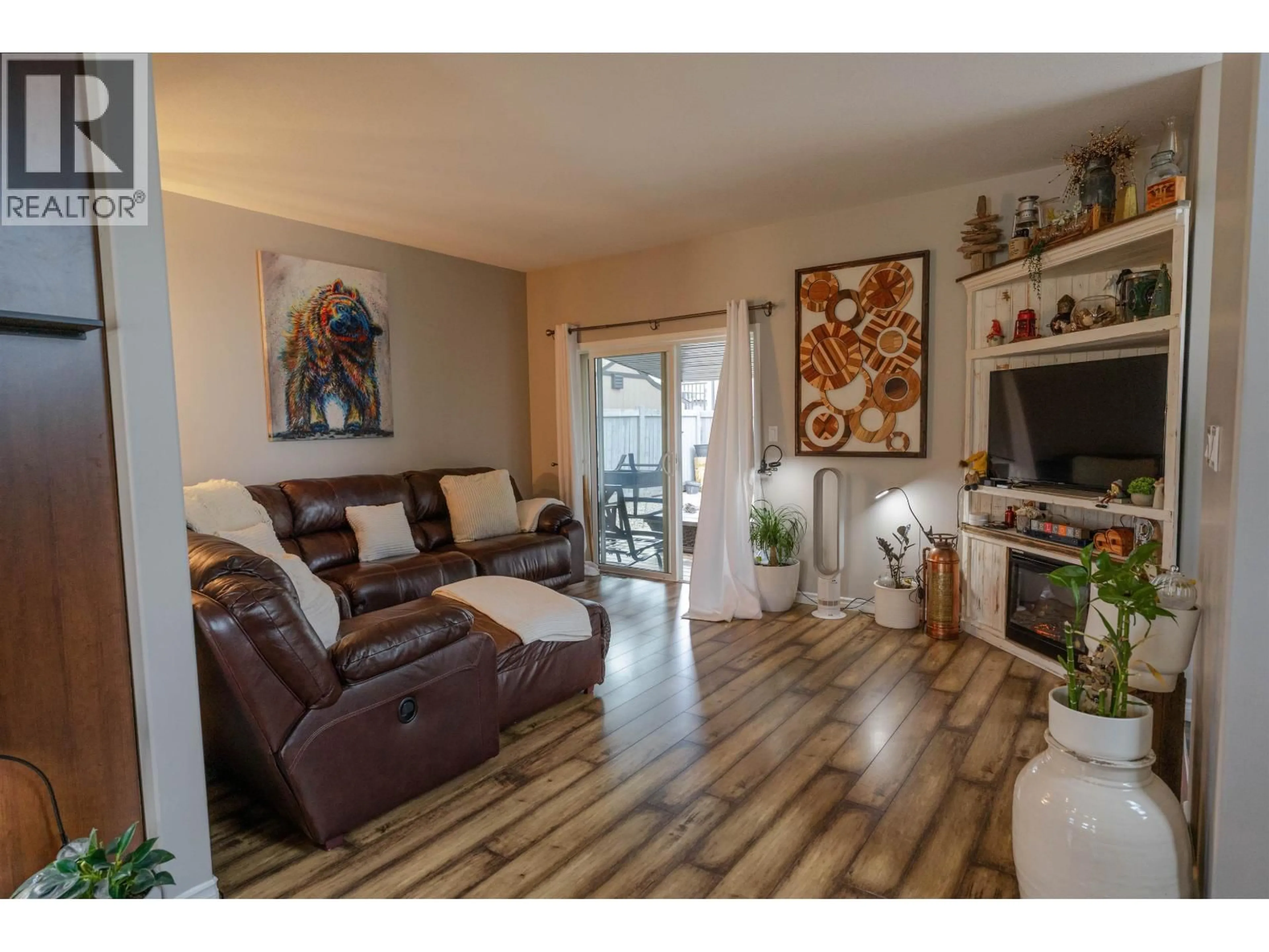Living room with furniture, wood/laminate floor for 8803 113 AVENUE, Fort St. John British Columbia V1J0E2