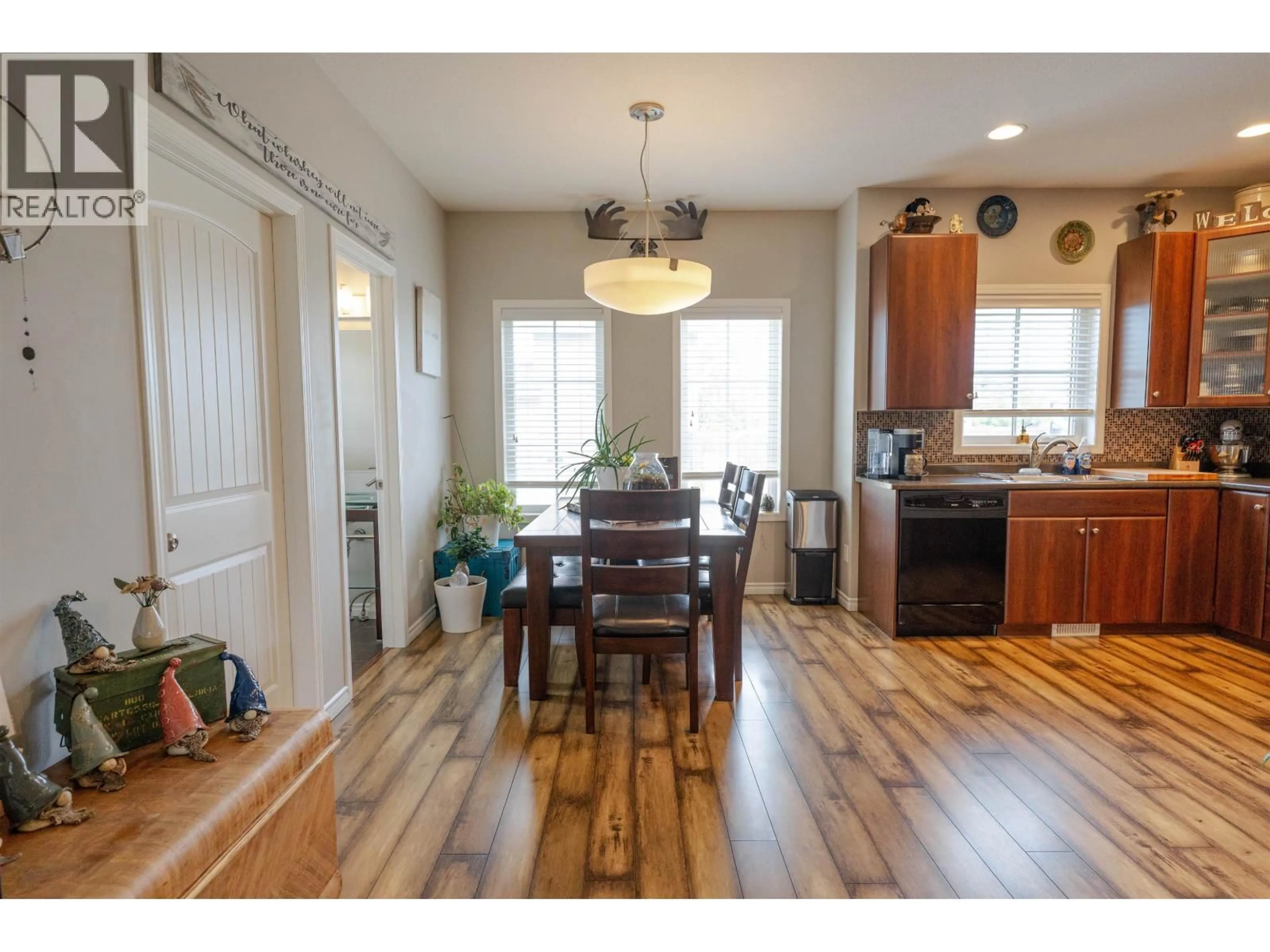 Open concept kitchen, wood/laminate floor for 8803 113 AVENUE, Fort St. John British Columbia V1J0E2