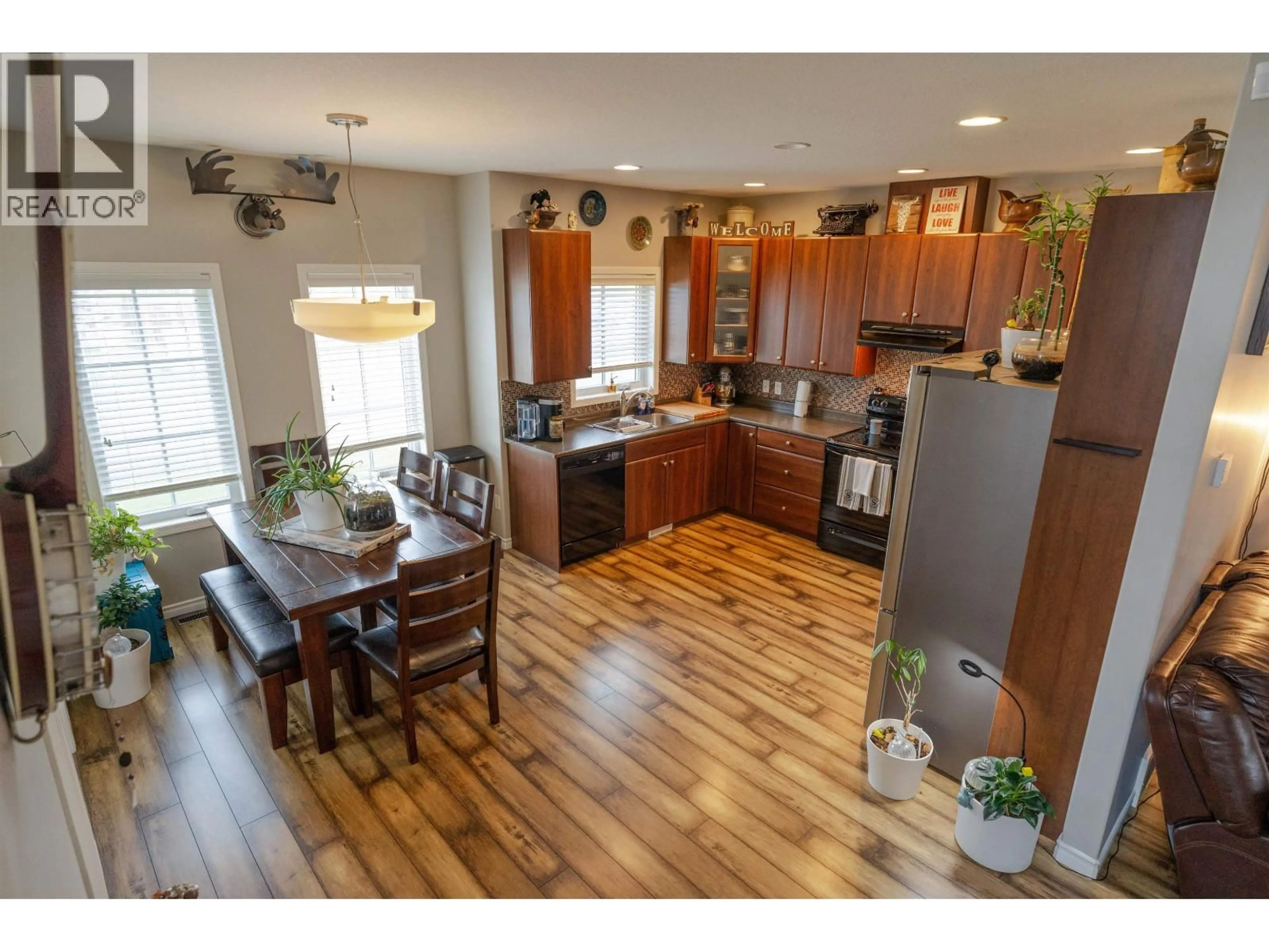 Open concept kitchen, wood/laminate floor for 8803 113 AVENUE, Fort St. John British Columbia V1J0E2