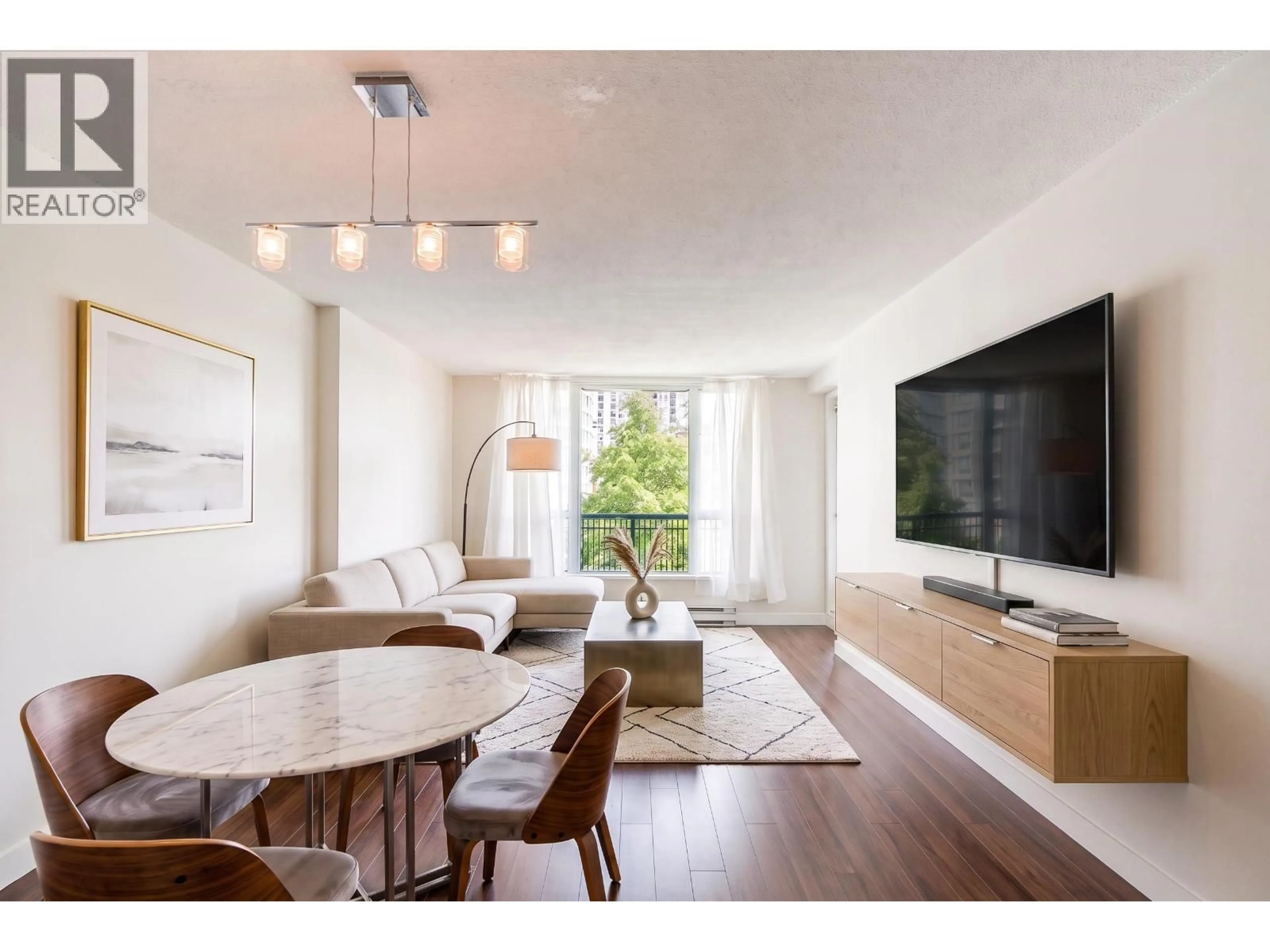 Living room with furniture, wood/laminate floor for 504 - 5189 GASTON STREET, Vancouver British Columbia V5R6C7