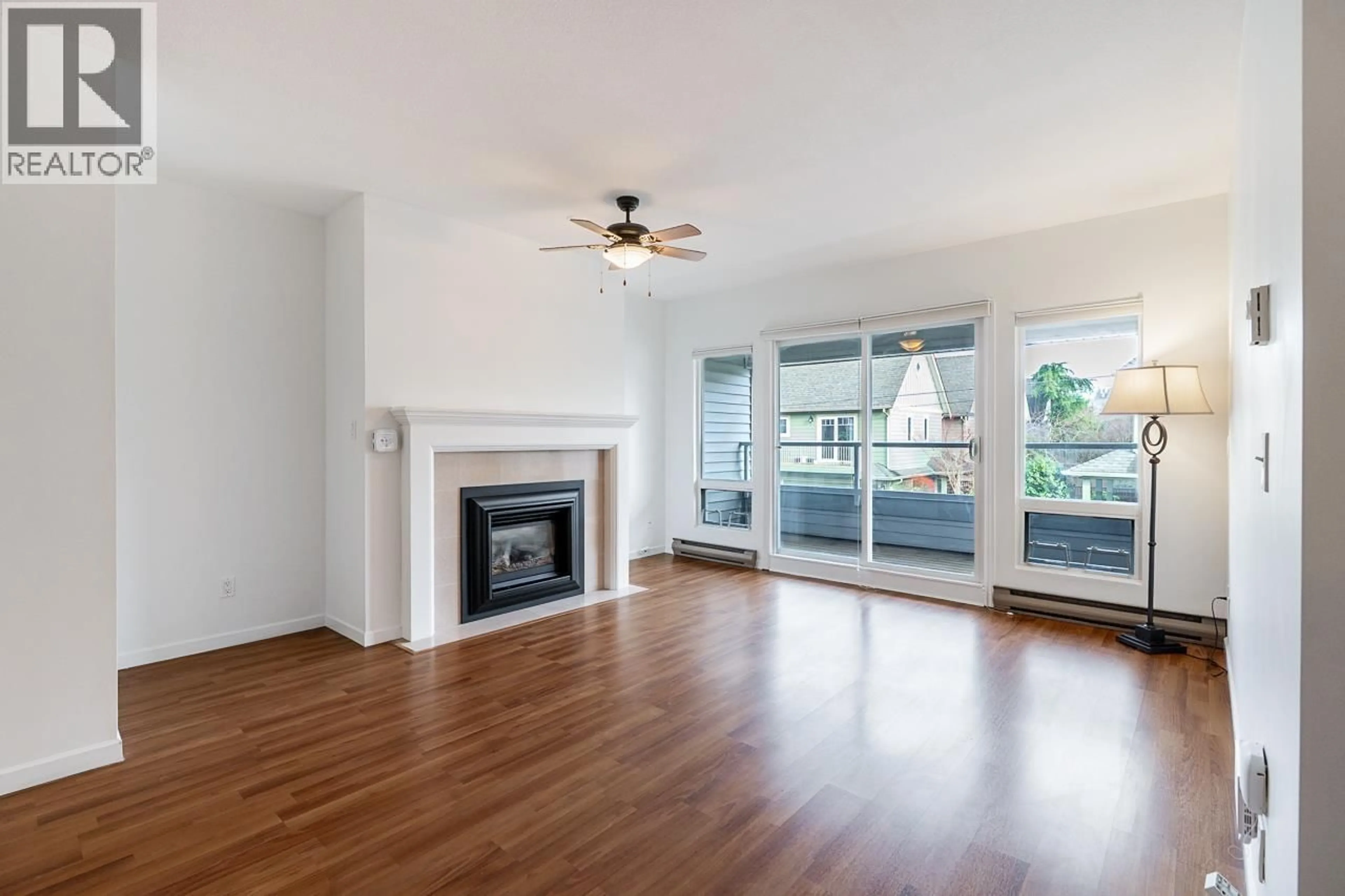 Living room with furniture, wood/laminate floor for 208 - 4989 47 AVENUE, Ladner British Columbia V4K1R1