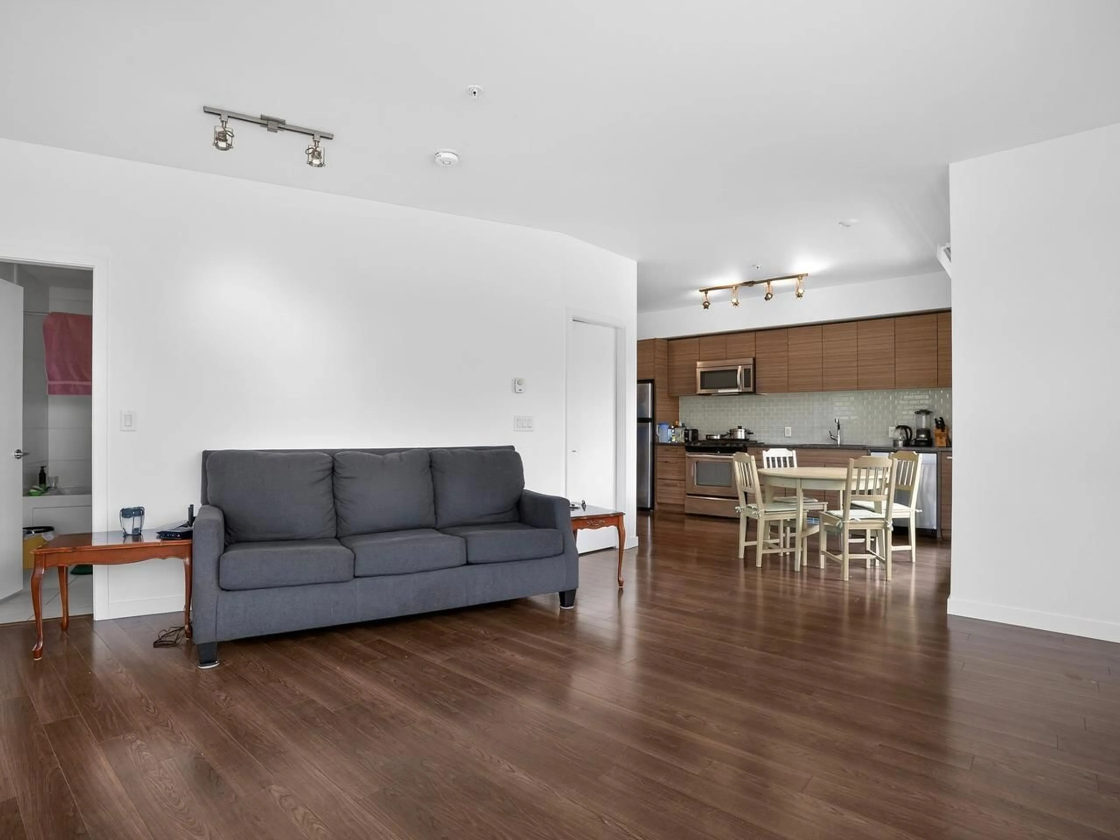 Living room with furniture, wood/laminate floor for 200 - 13228 OLD YALE ROAD, Surrey British Columbia V3T0K3