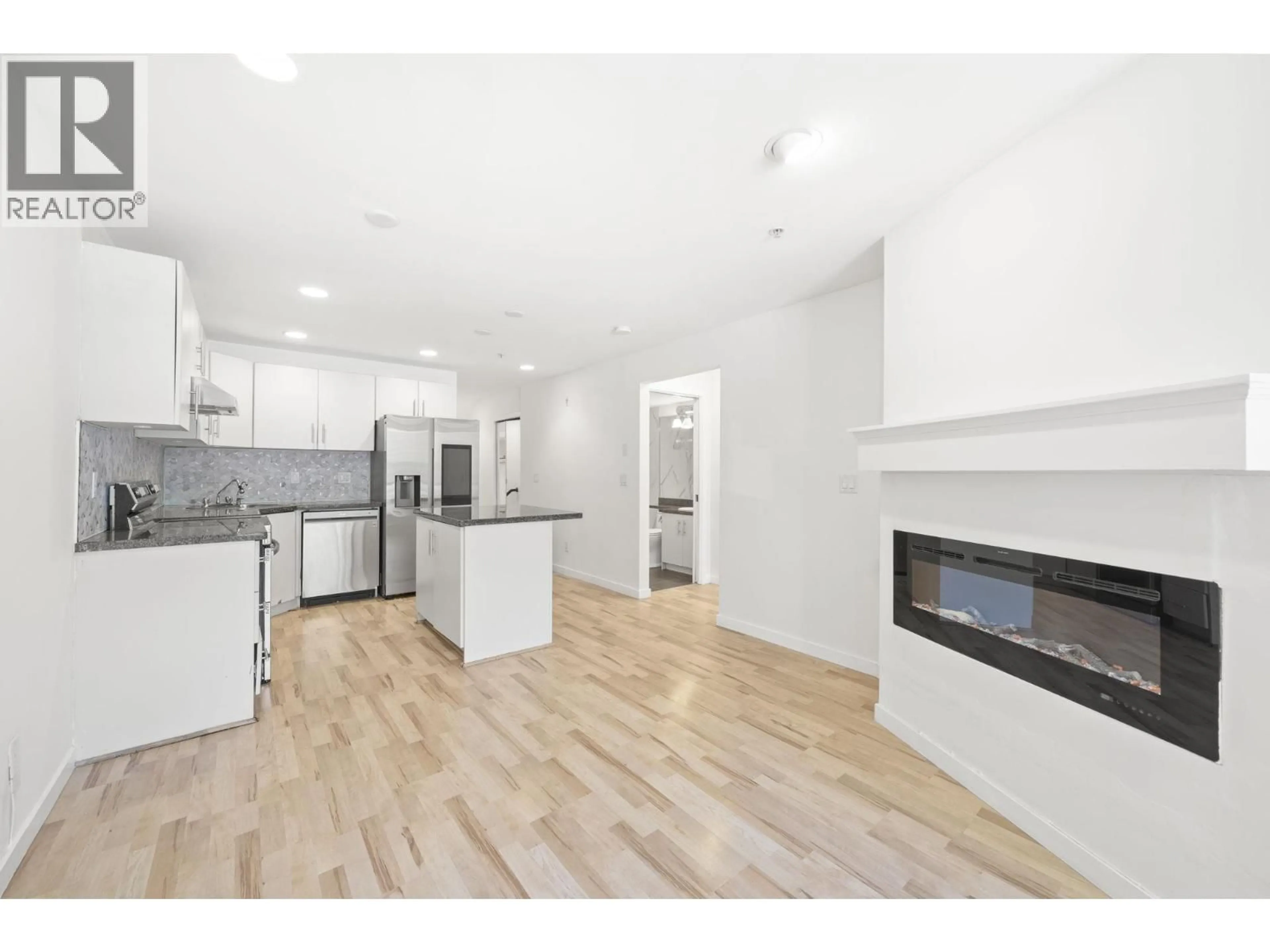 Open concept kitchen, wood/laminate floor for 105 - 5025 JOYCE STREET, Vancouver British Columbia V5R4G7