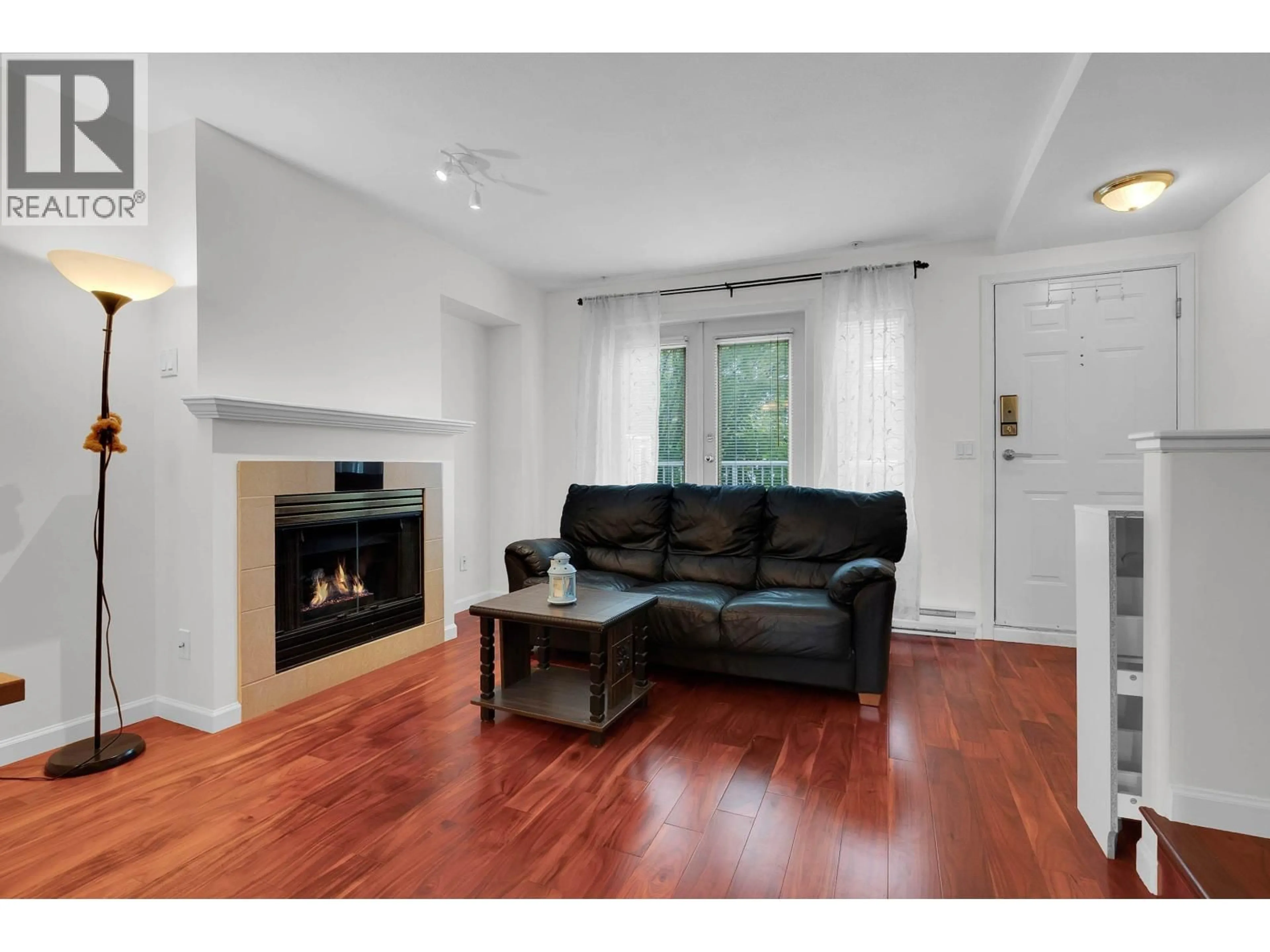 Living room with furniture, wood/laminate floor for 117 - 6588 SOUTHOAKS CRESCENT, Burnaby British Columbia V5E4K1
