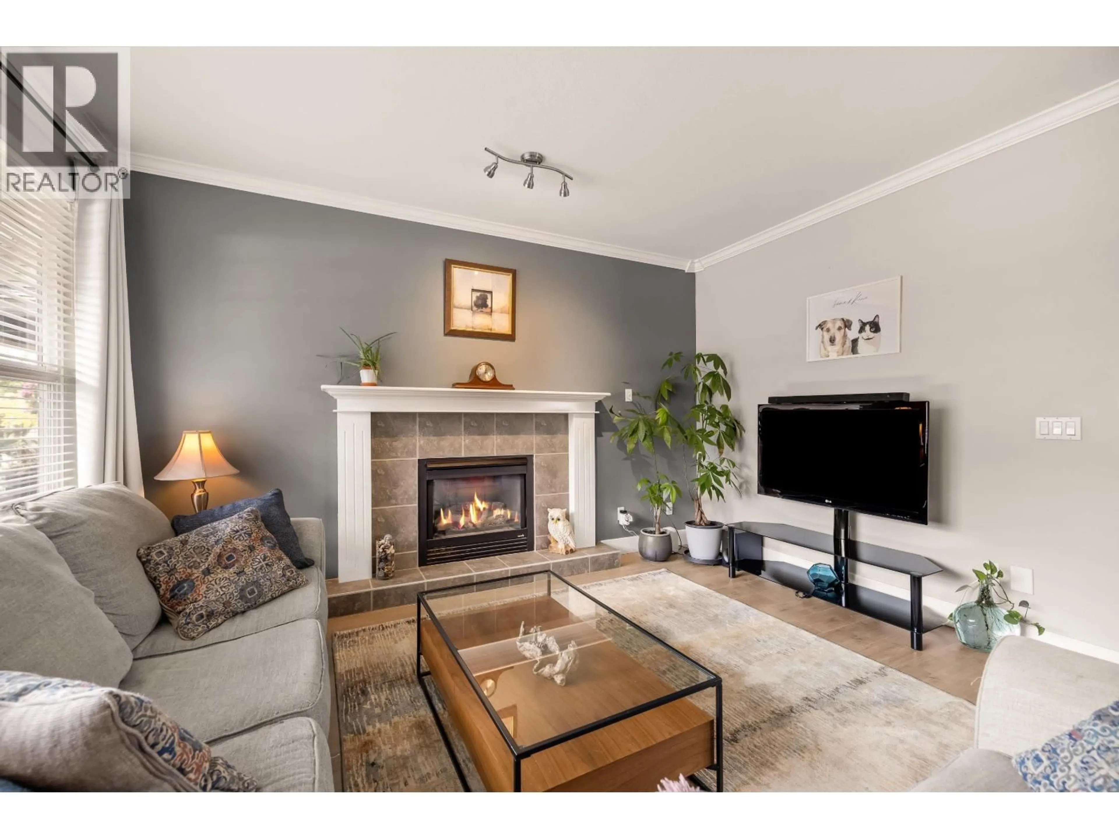 Living room with furniture, wood/laminate floor for 24327 102 AVENUE, Maple Ridge British Columbia V2W1X9