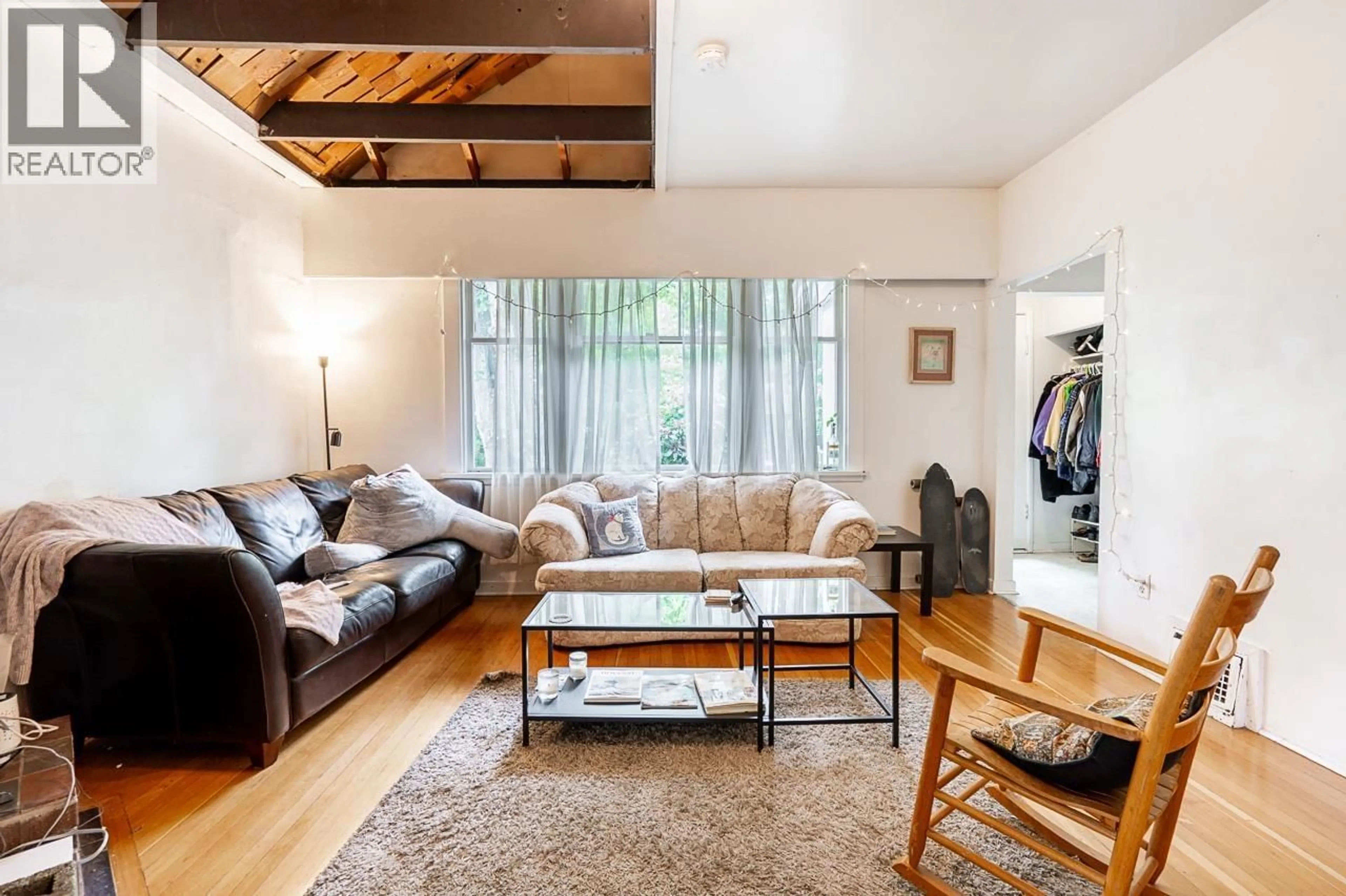 Living room with furniture, wood/laminate floor for 4413 13 AVENUE, Vancouver British Columbia V6R2V2