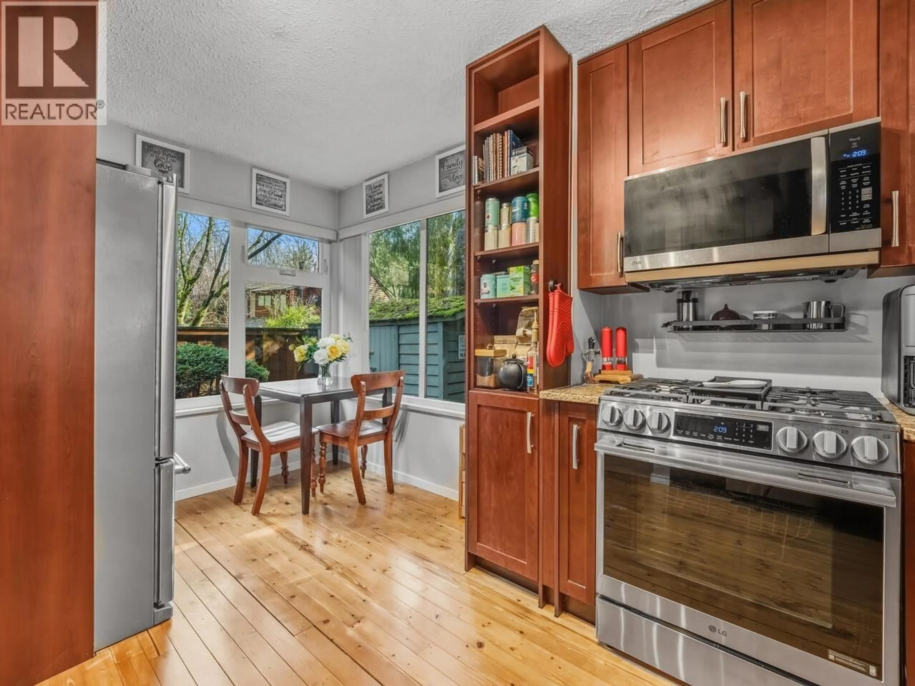 Open concept kitchen, wood/laminate floor for 4597 ELMGROVE DRIVE, Burnaby British Columbia V5G3Y9