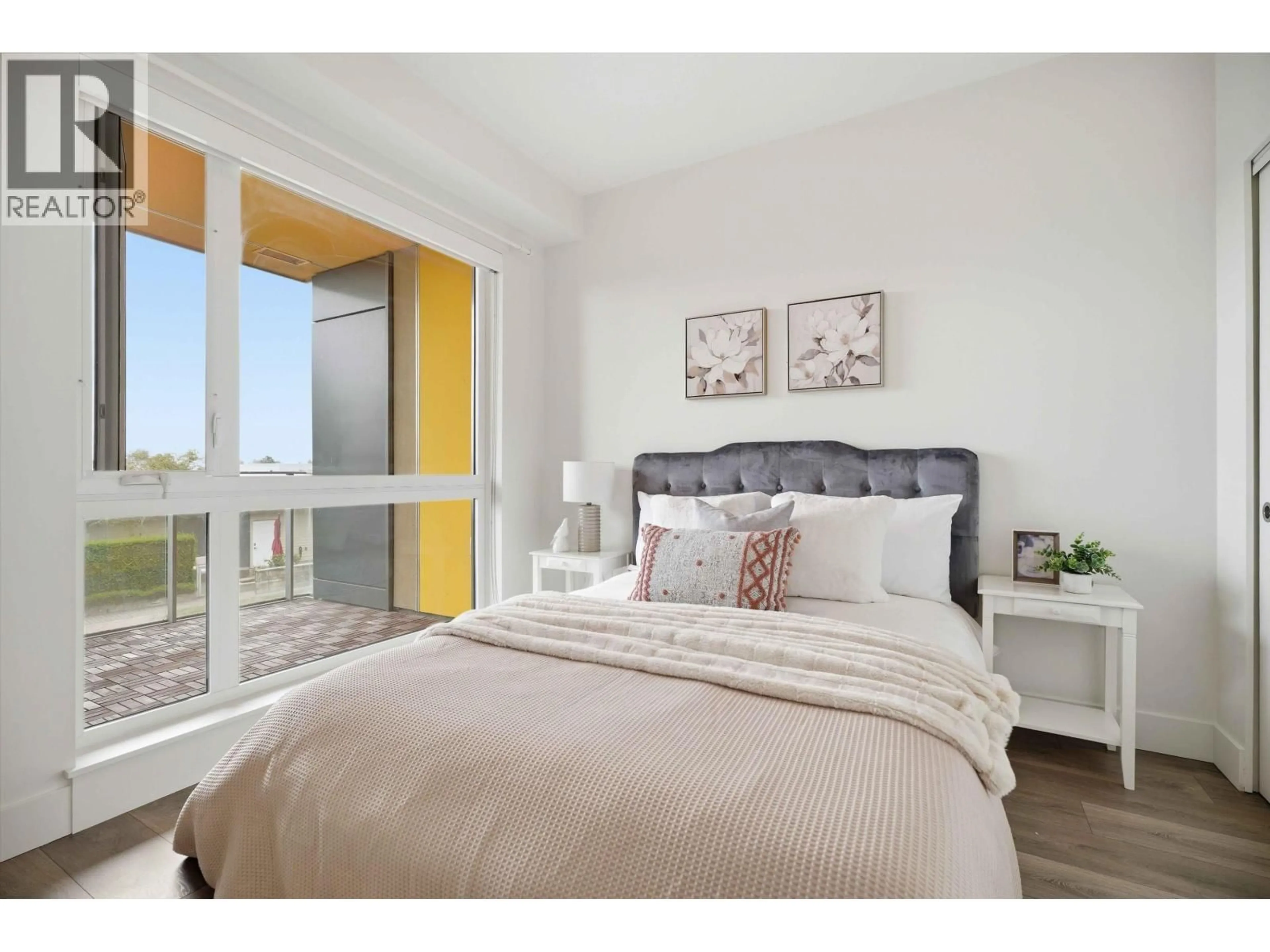 Bedroom with bed, wood/laminate floor for 515 - 8580 RIVER DISTRICT CROSSING, Vancouver British Columbia V5S0B9
