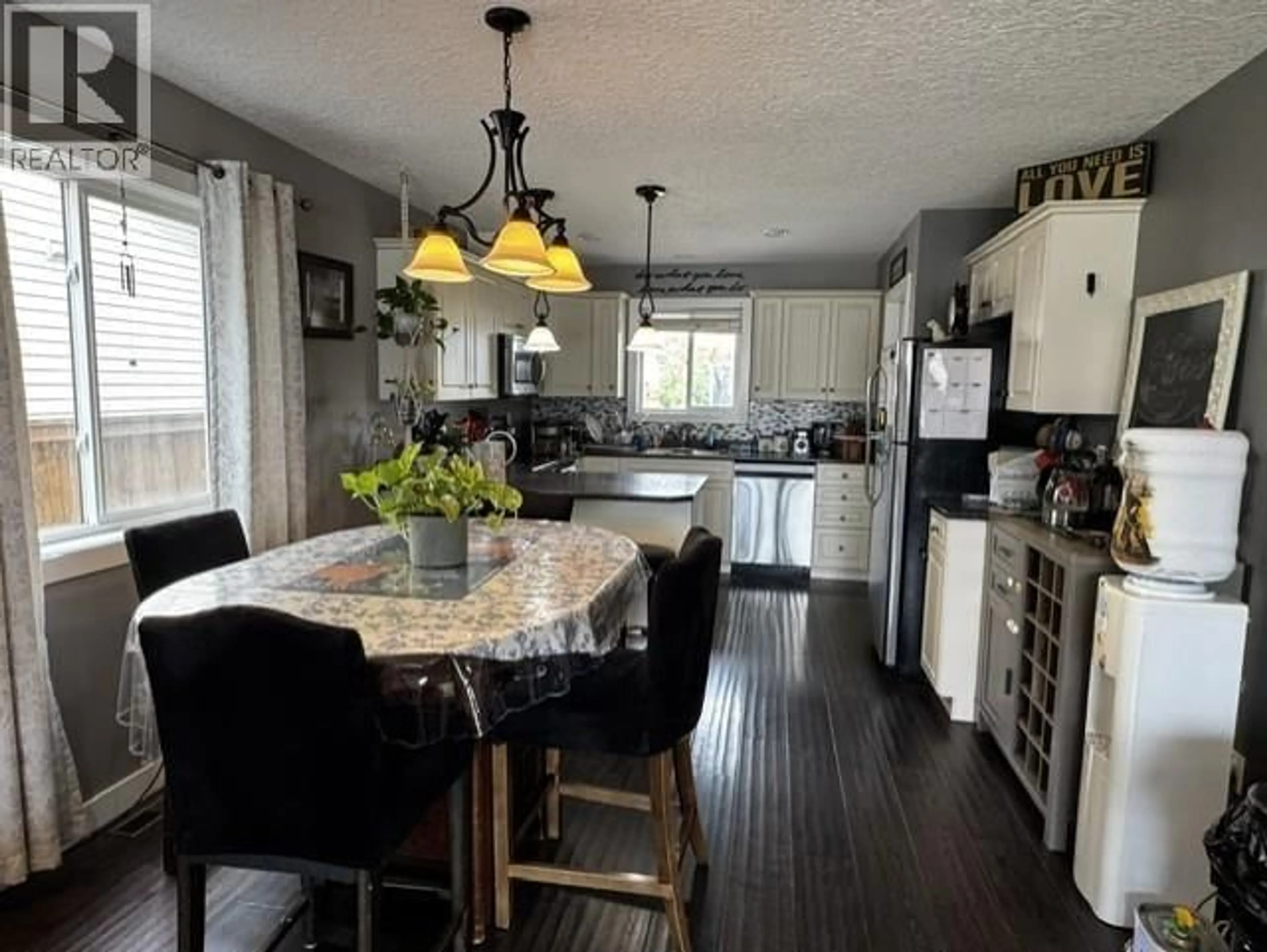 Open concept kitchen, wood/laminate floor for 8313 87 STREET, Fort St. John British Columbia V1J0H4