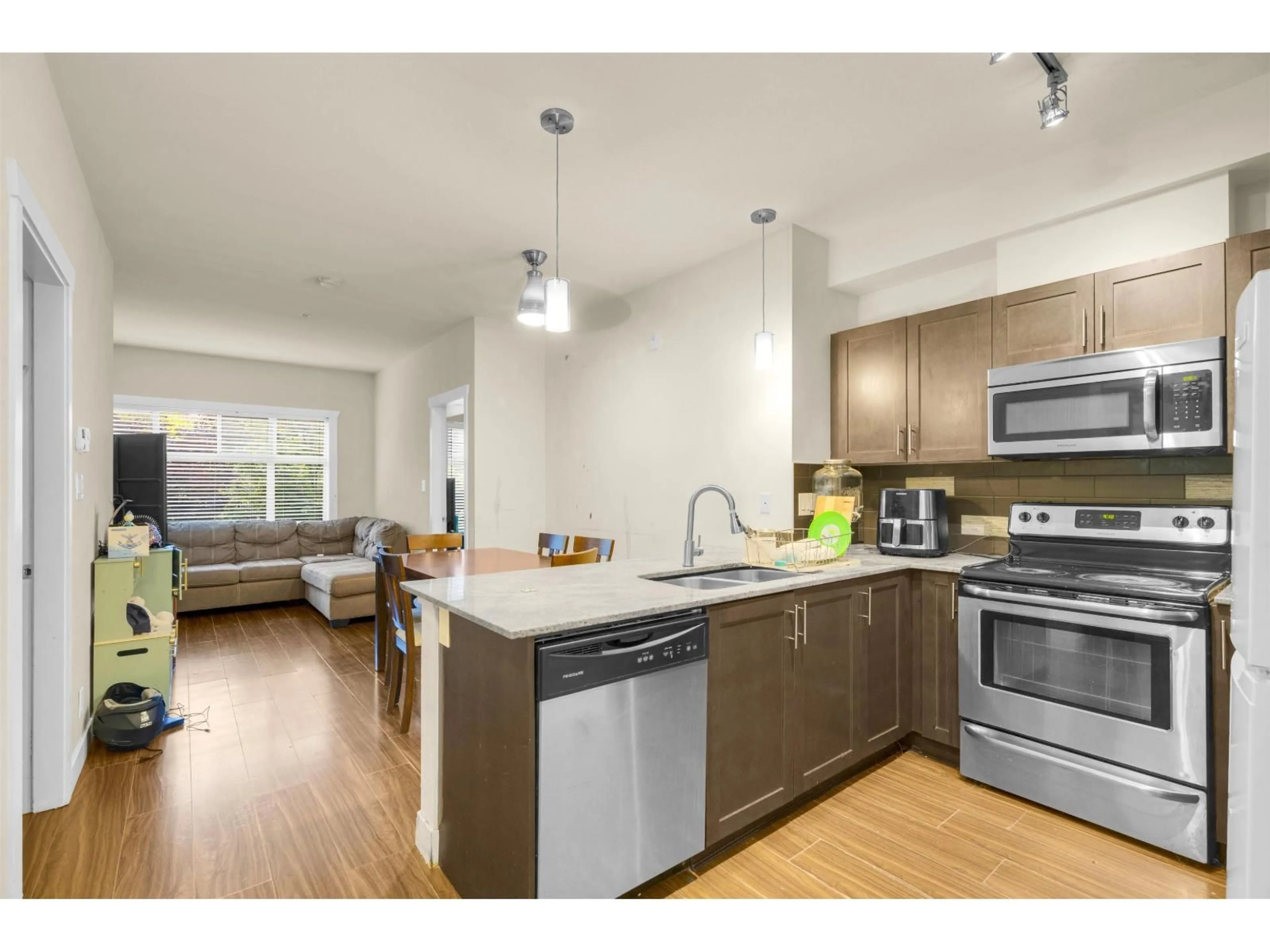 Open concept kitchen, wood/laminate floor for 110 - 13468 KING GEORGE BOULEVARD, Surrey British Columbia V3T0H5